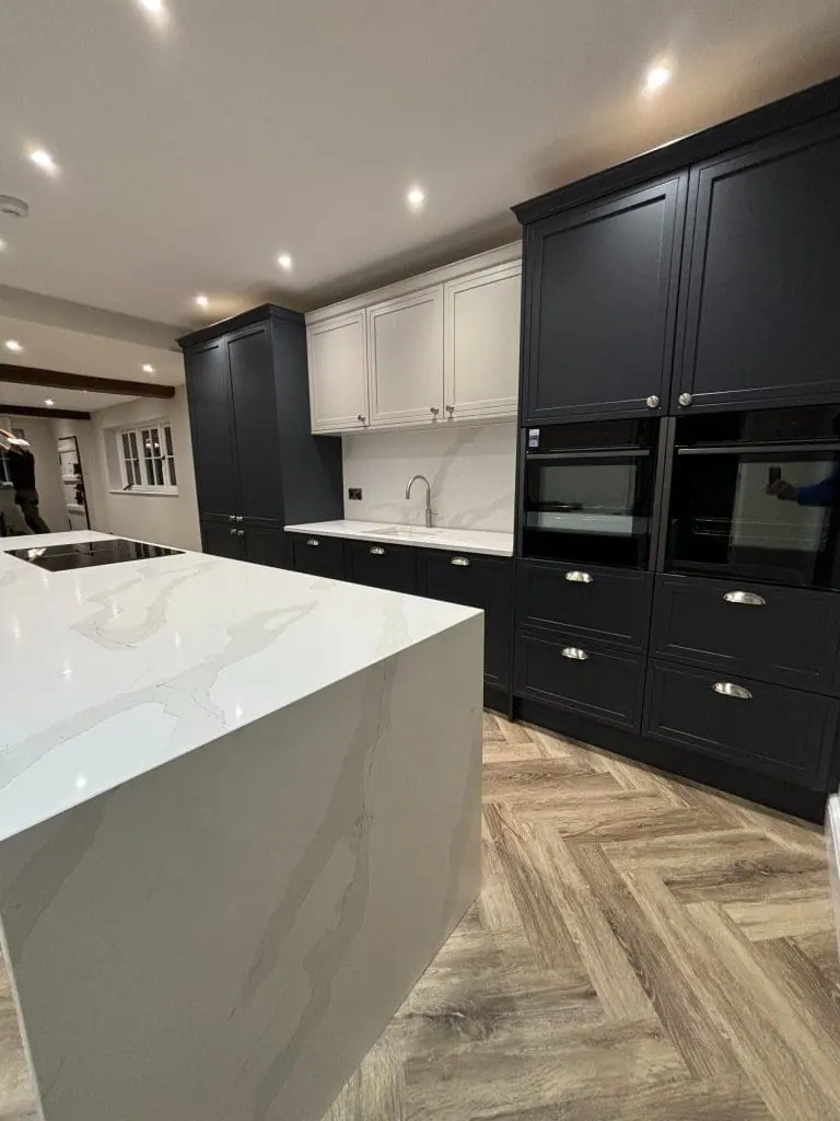 White bespoke kitchen under exposed oak roof beams