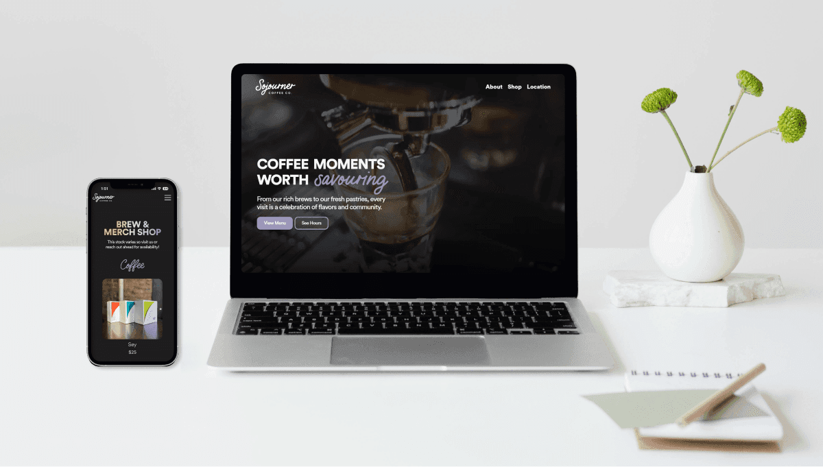 Mac and IPhone on white office desk displaying website mockups