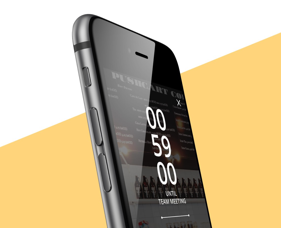 A black smartphone displays a digital clock showing "00:59" and "Until Team Meeting". The screen also shows "Pushcart Co." at the top and images of beer bottles along the bottom. The phone is angled slightly against a yellow and white background.
