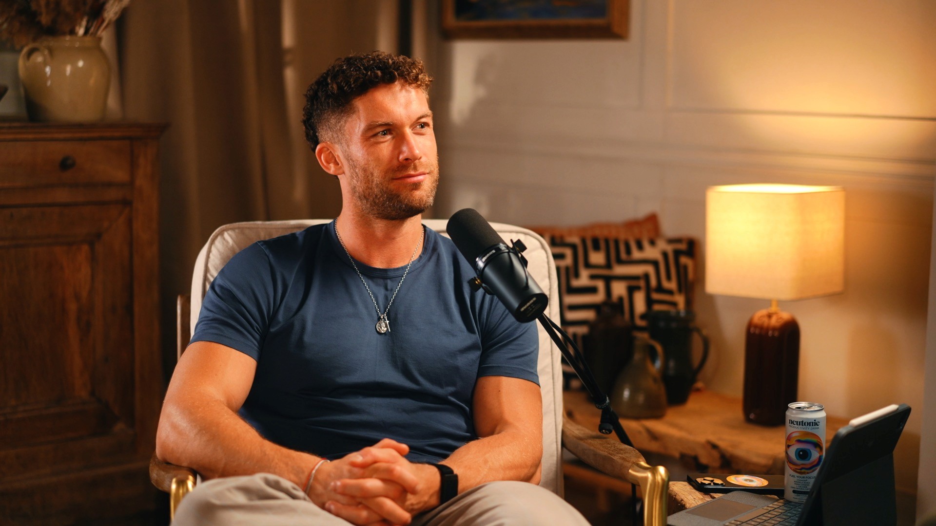 Male podcast guest speaking into microphone in professional podcast studio setup”