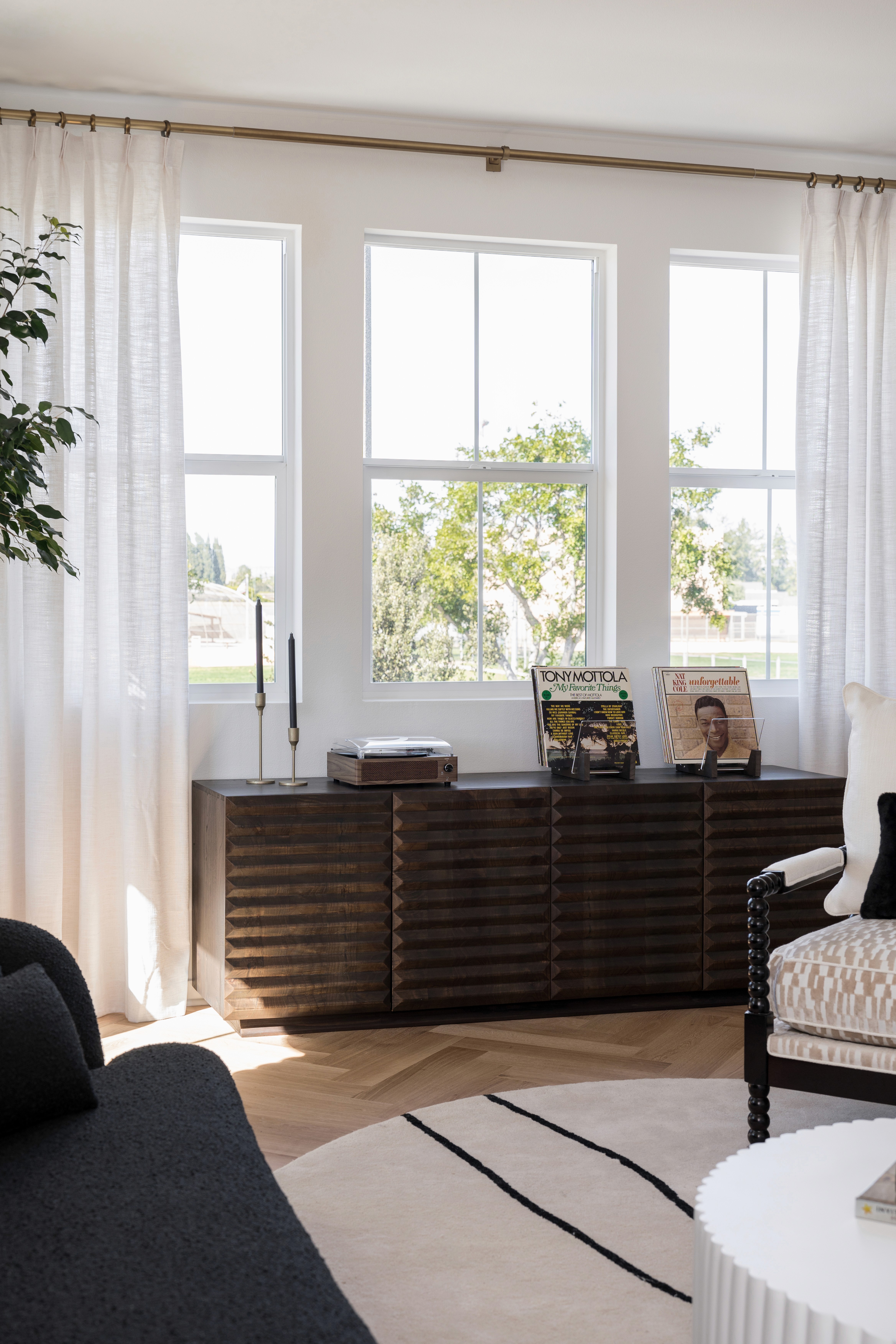 dark, wood console table with tapers and records displayed