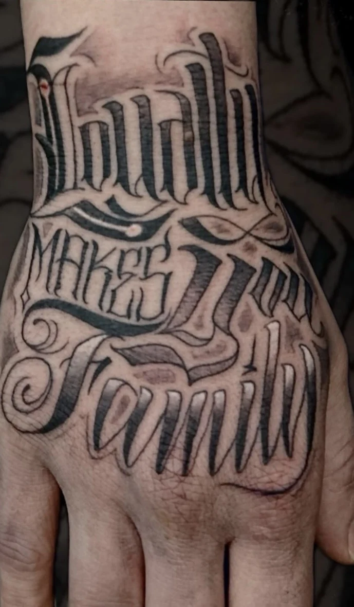 Custom lettering hand tattoo by Tomski
