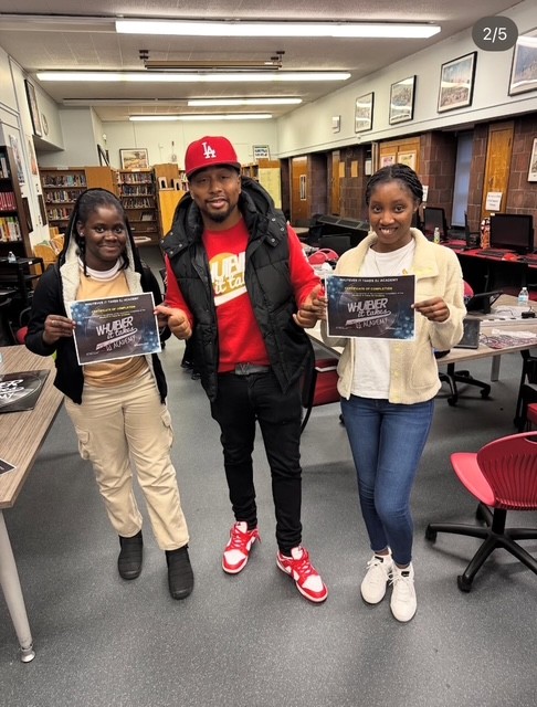 DJ Whutever poses with two participants and their certifications.