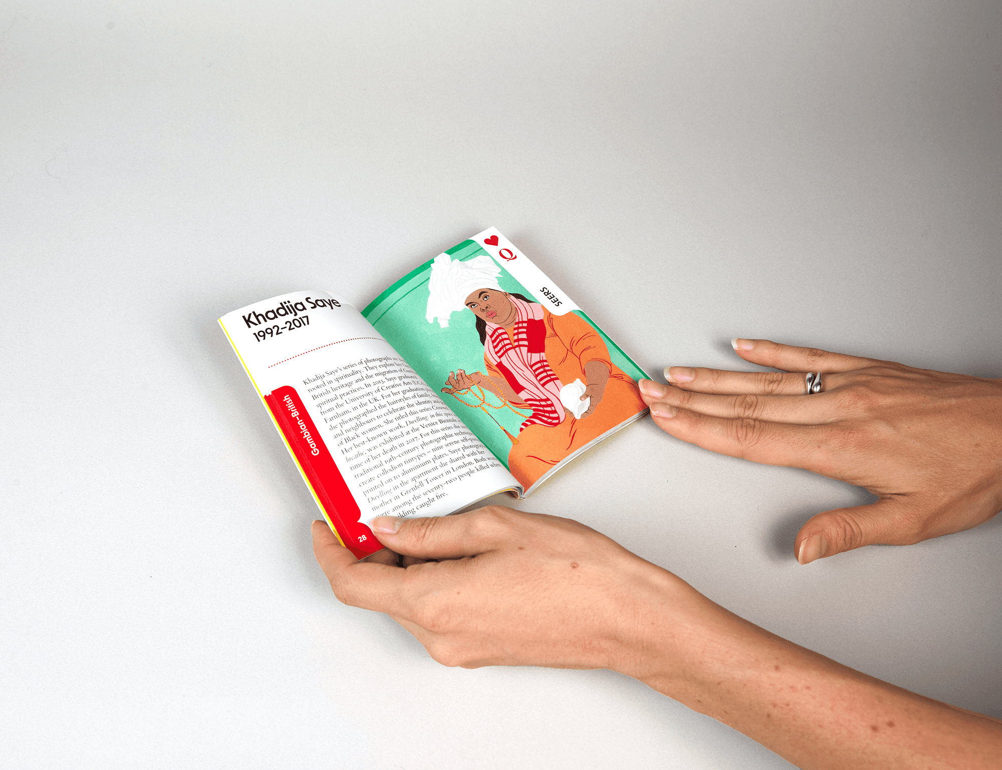 Editorial leaflet from the Gift Lab collection opened by hand, showing colorful illustrated spreads.