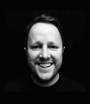 A professional headshot of a man