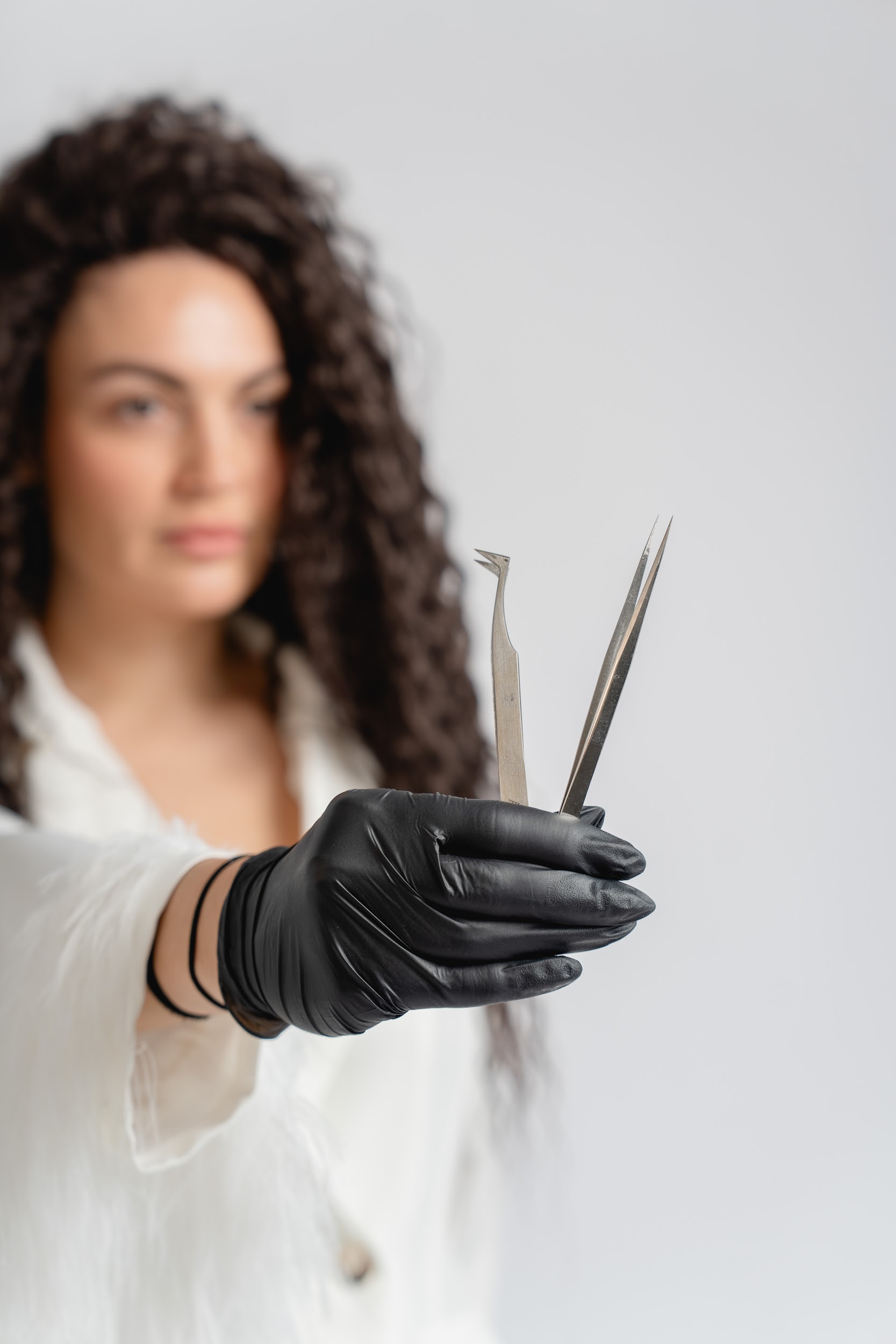 Professional headshot of a person in a formal setting.
