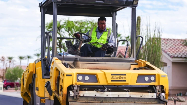 Closeup photo of asphalt rollerman on roller