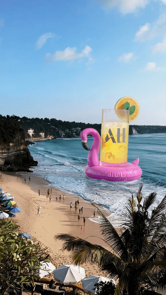 A giant All drink in a flamingo floatie drifting near a crowded beach