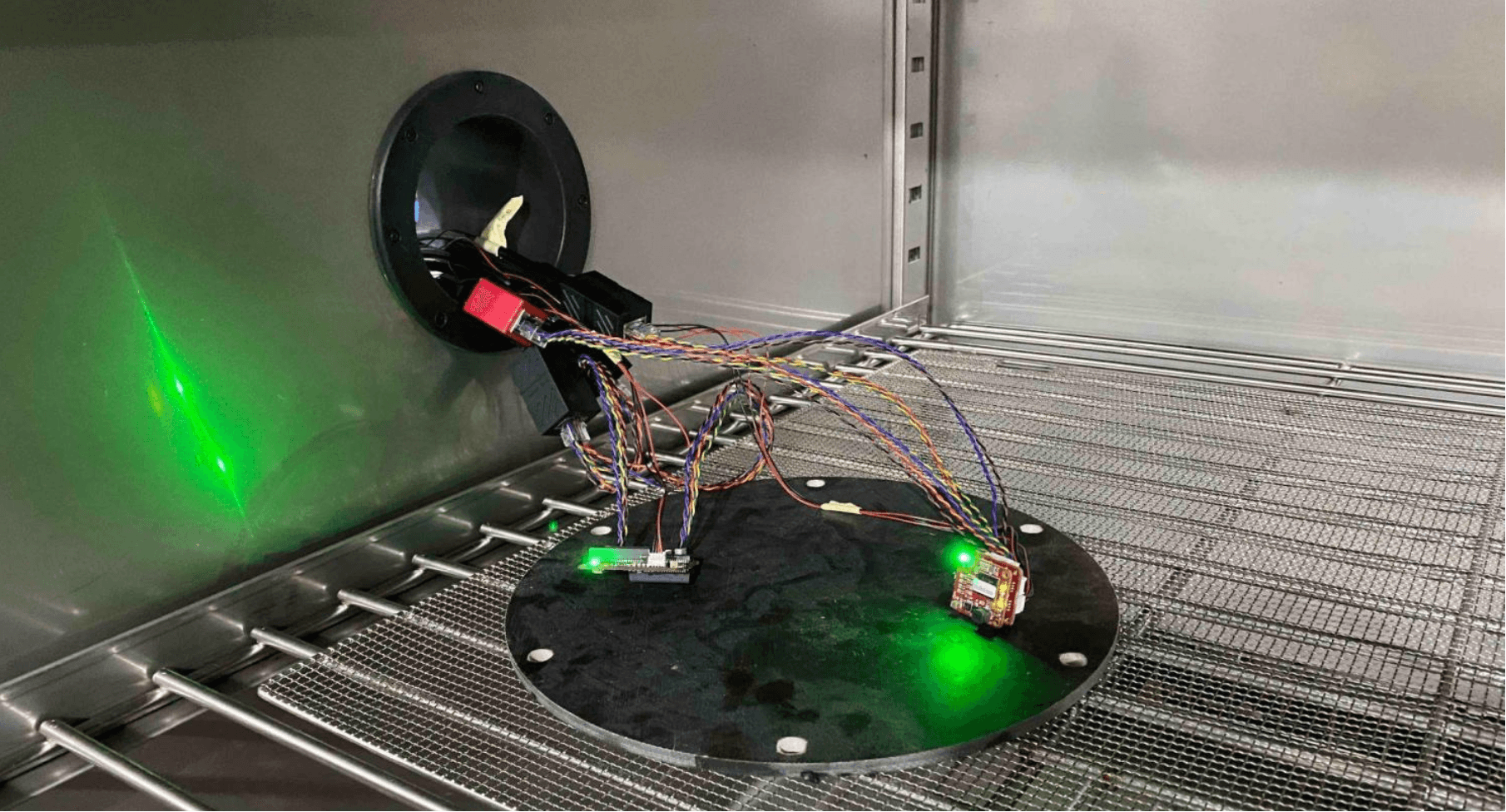 Inside the test chamber: BotBlox boards mounted on a platter with status LEDs on during operational testing
