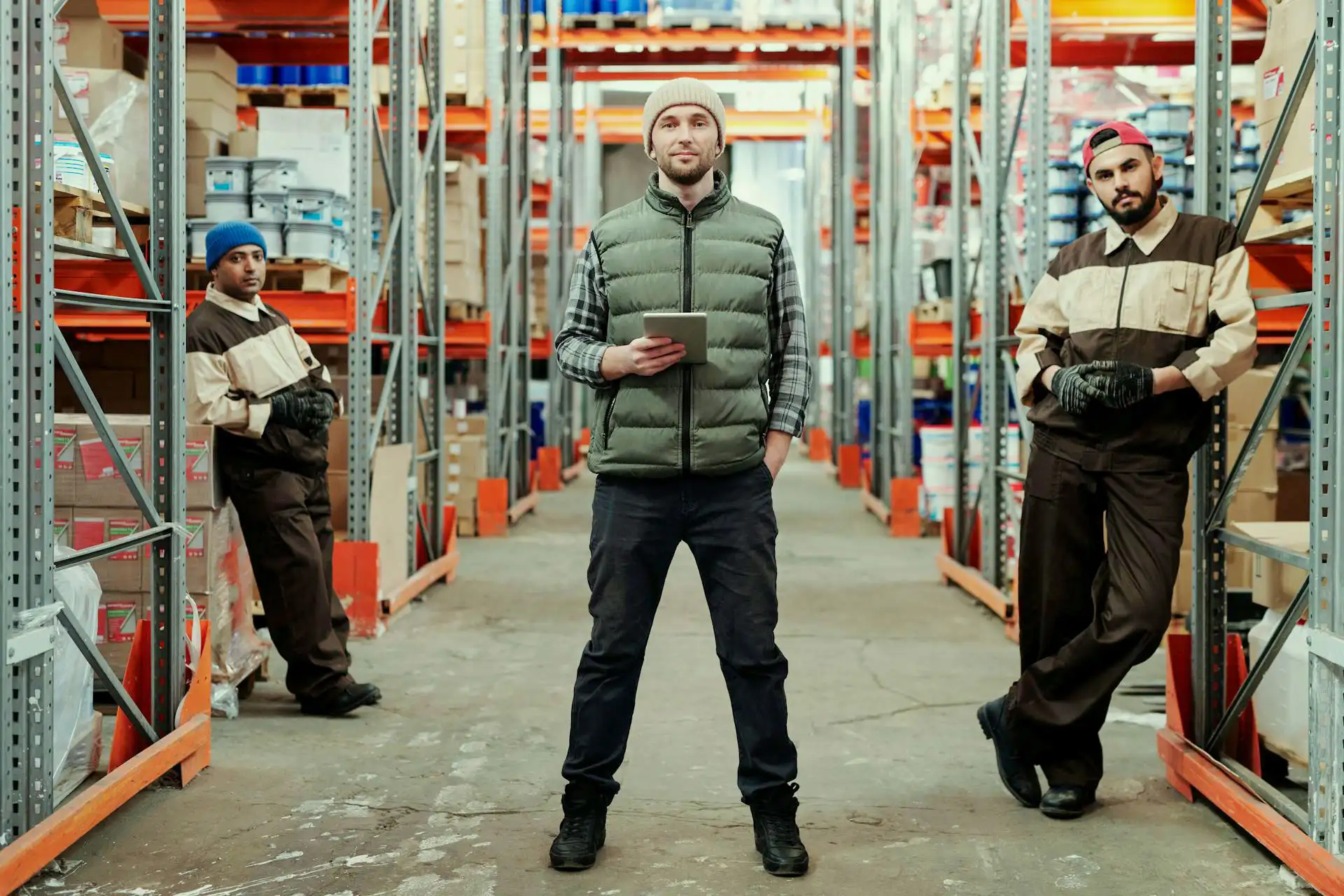 Workers in warehouse posing to the camera.