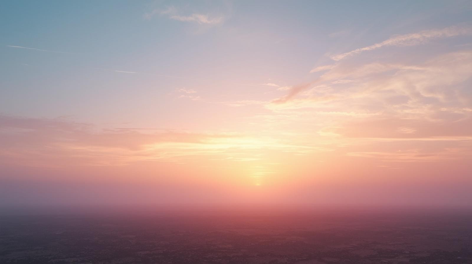 Early morning sky with soft pink and blue gradient over open landscape