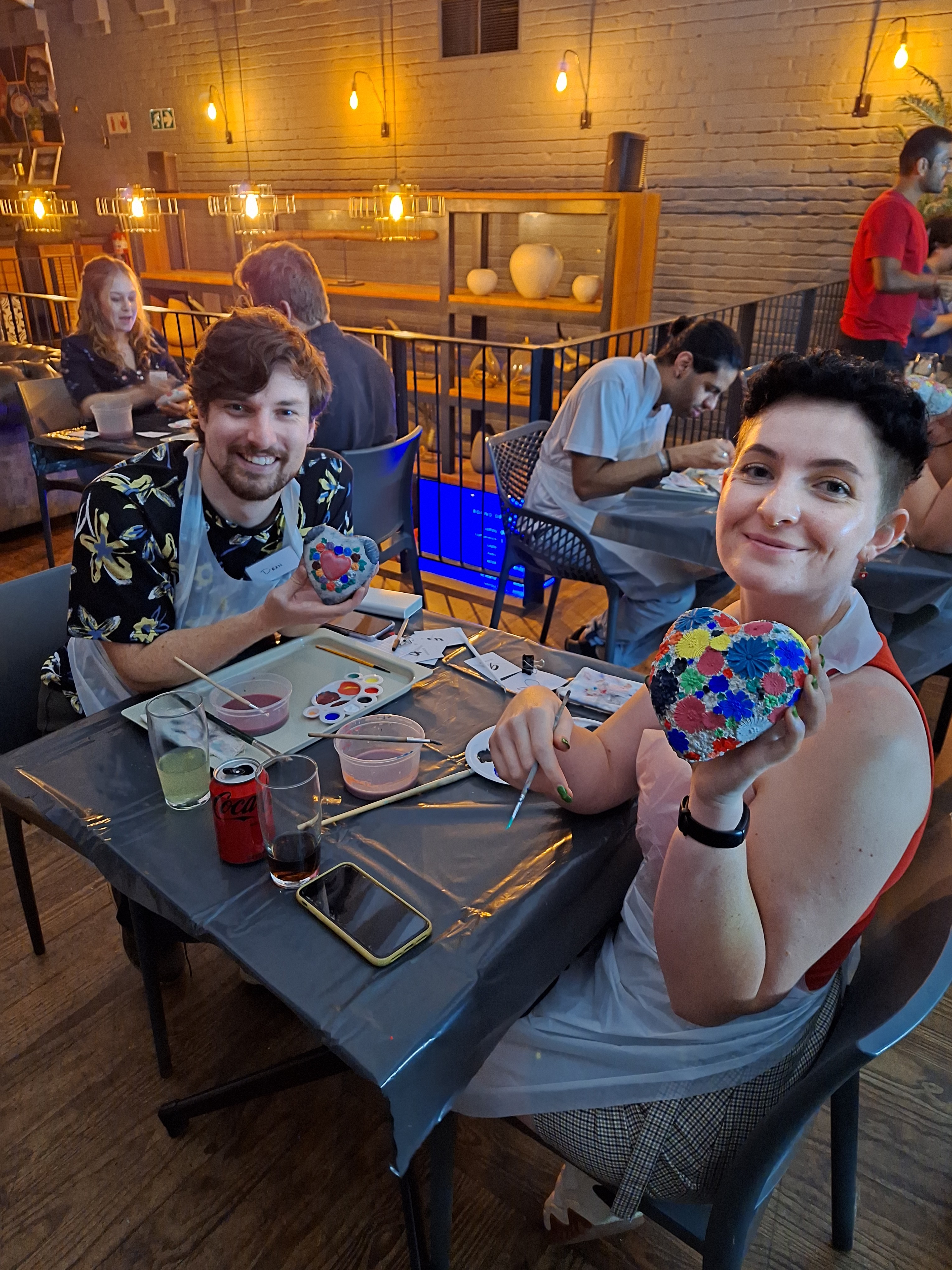 A couple showing their artwork
