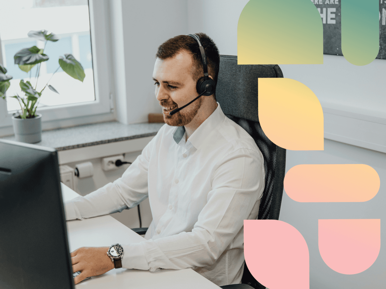 man sitting in front of a computer with headset on 