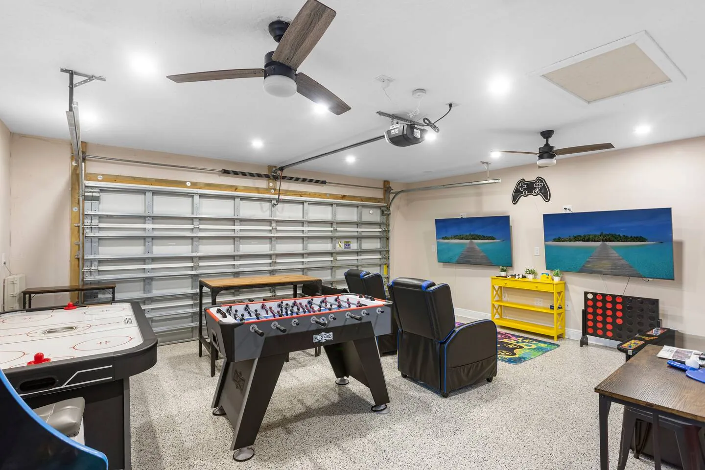 Game room with air hockey, foosball and TVs at Sarasota Beach Bungalow, Bradenton, Florida