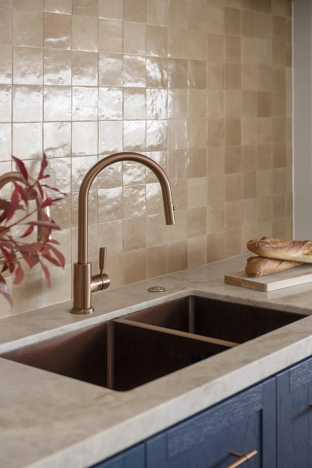 Kitchen detail with copper range hood, tiled splashback, and freestanding stove with cookware.