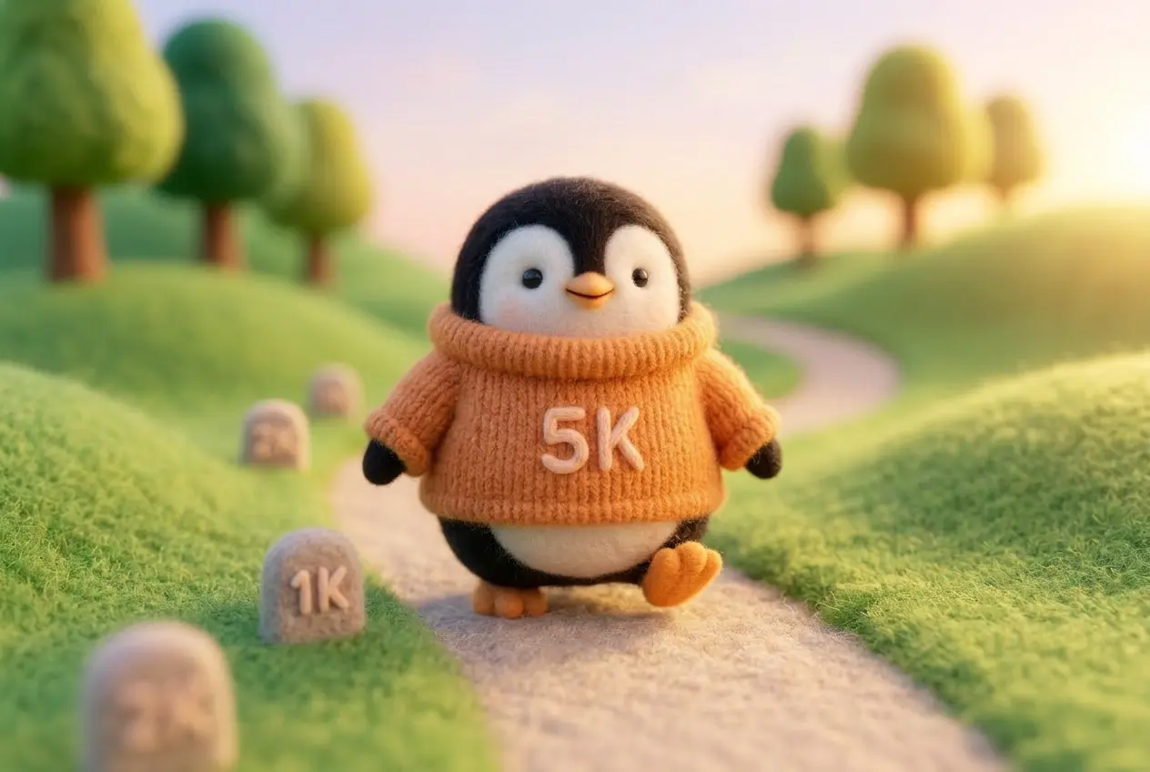 A wool felt penguin in an orange sweater walking along a gentle path with small milestones, representing the walk-run training method