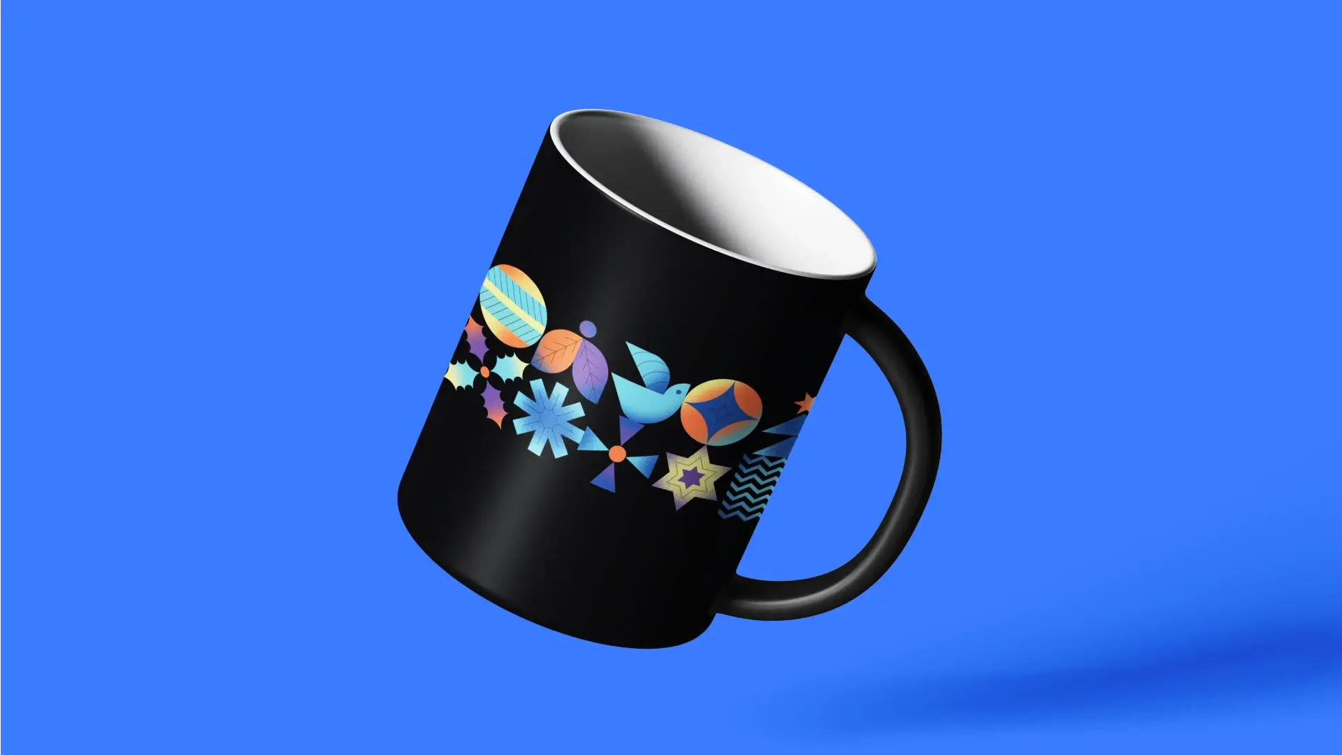 A black mug with colorful geometric and nature-inspired patterns, including birds and stars, stacked against a vibrant blue background.