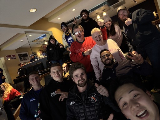 Group photo of VSG Power team members smiling at an indoor event.