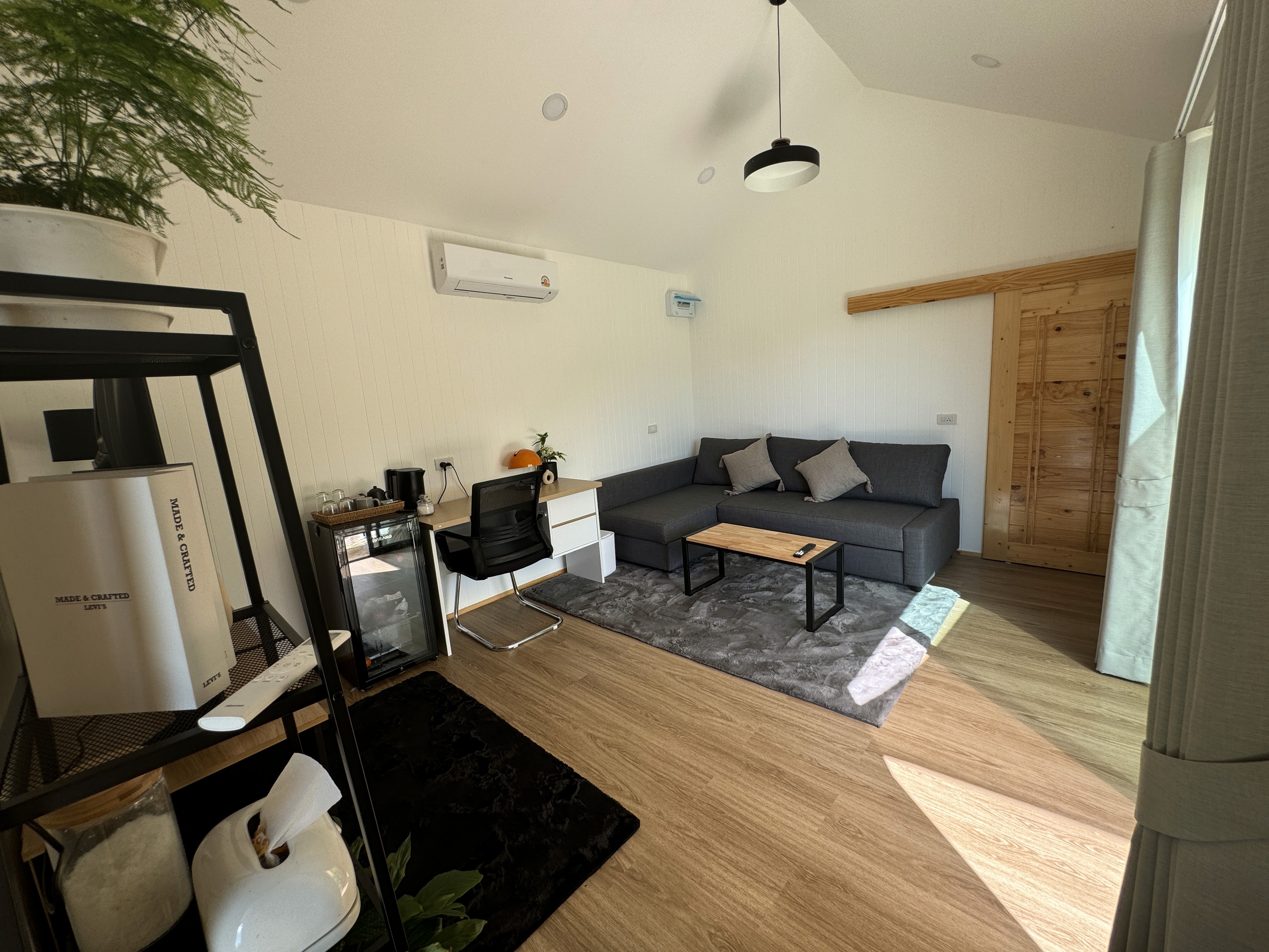 A comfortable corner featuring a dedicated work desk, high-speed internet setup, and a private minibar fridge.
