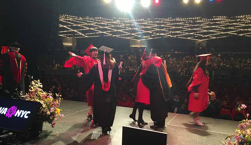 students hugging and in joy at the graduation