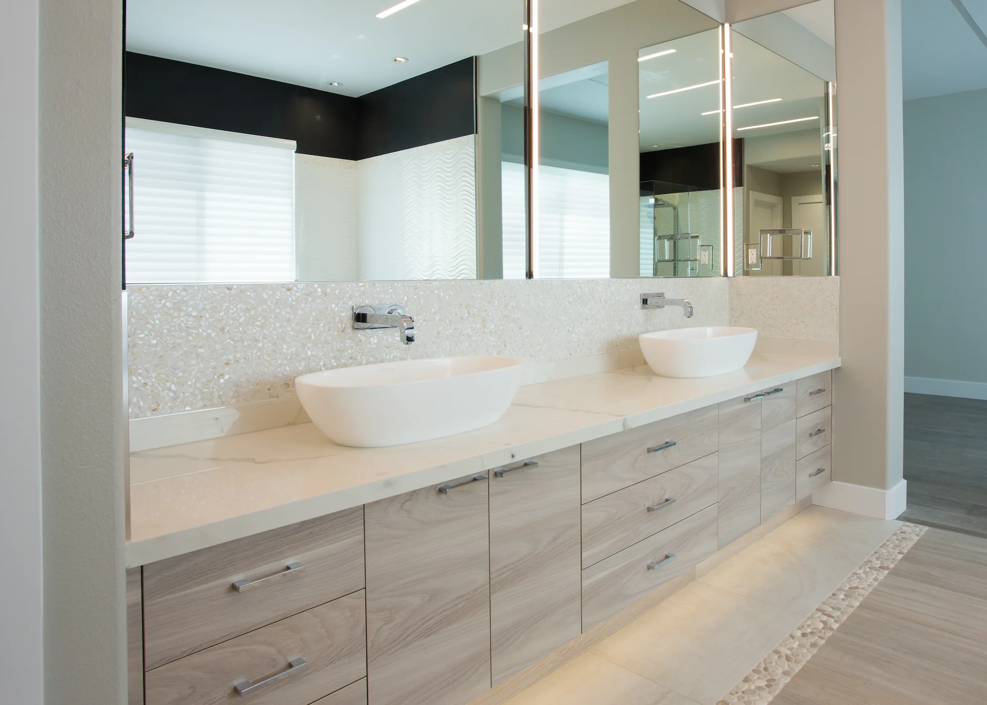 View from angle 2 of the master bath's double vanity, highlighting the modern aesthetics and luxurious feel in this Newport Beach home.