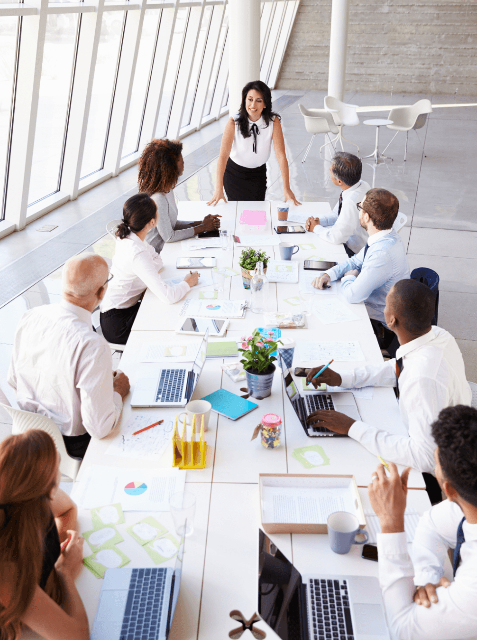 Female executive leading a board meeting: executive presentation skills and strategic communication workshops for leaders.