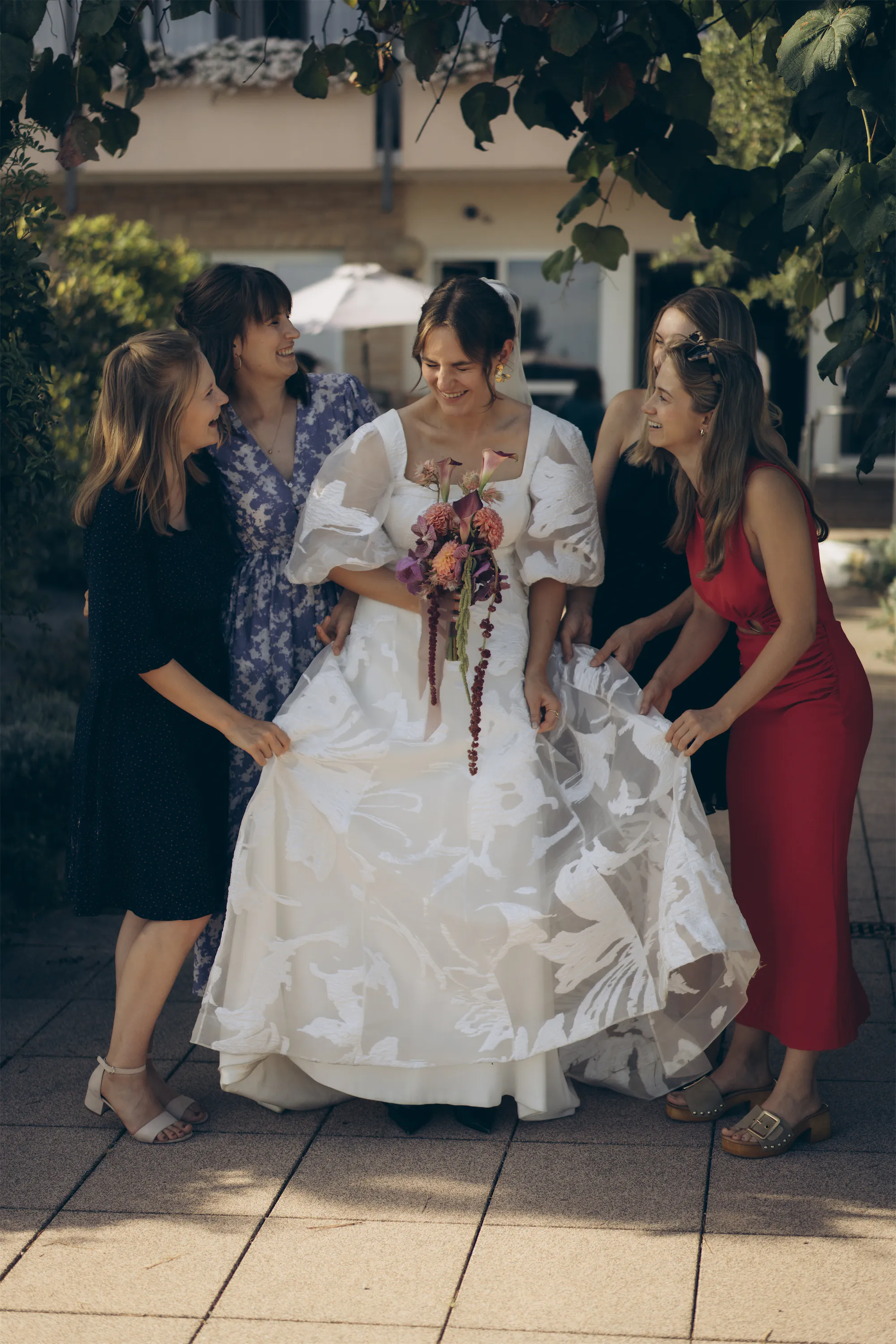 Authentic wedding photography capturing emotional moments between family and bride.