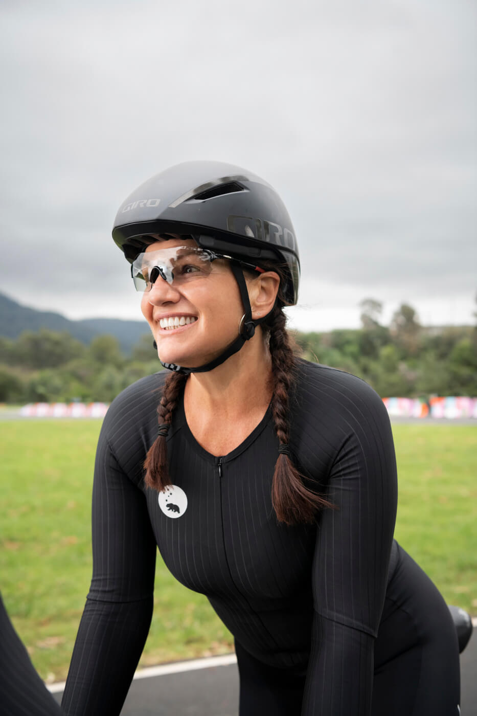 Lily in her cycling kit, smiling and looking off to the left