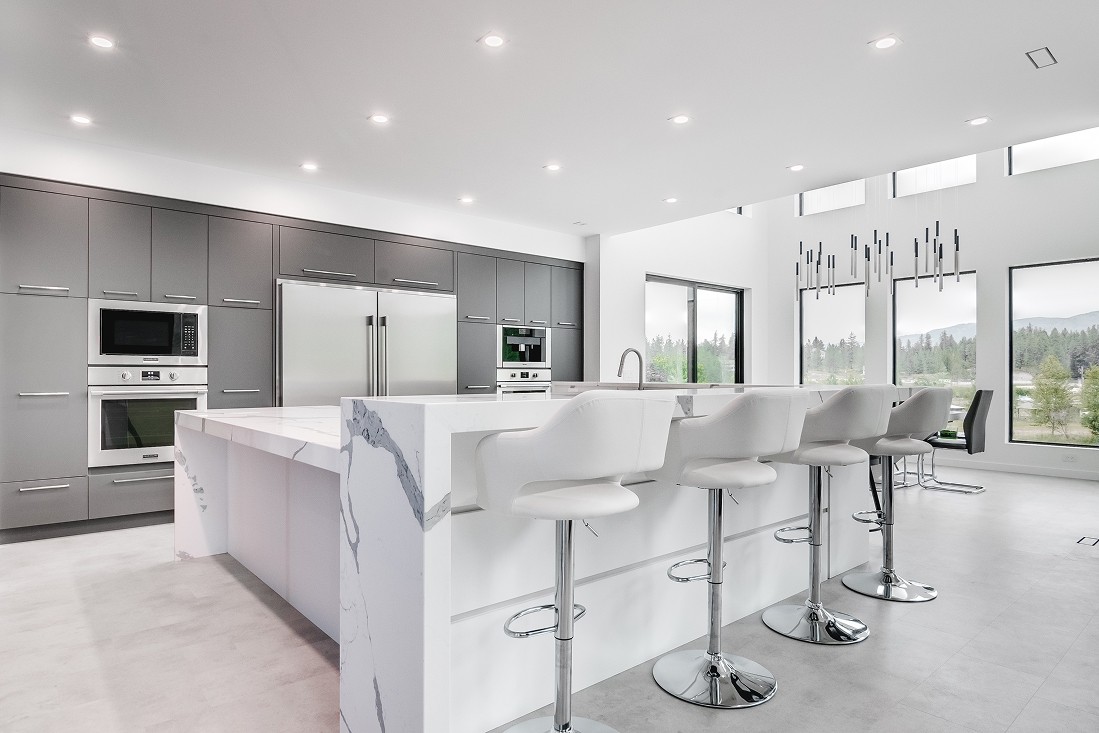 Bright kitchen with custom cabinetry and seating area