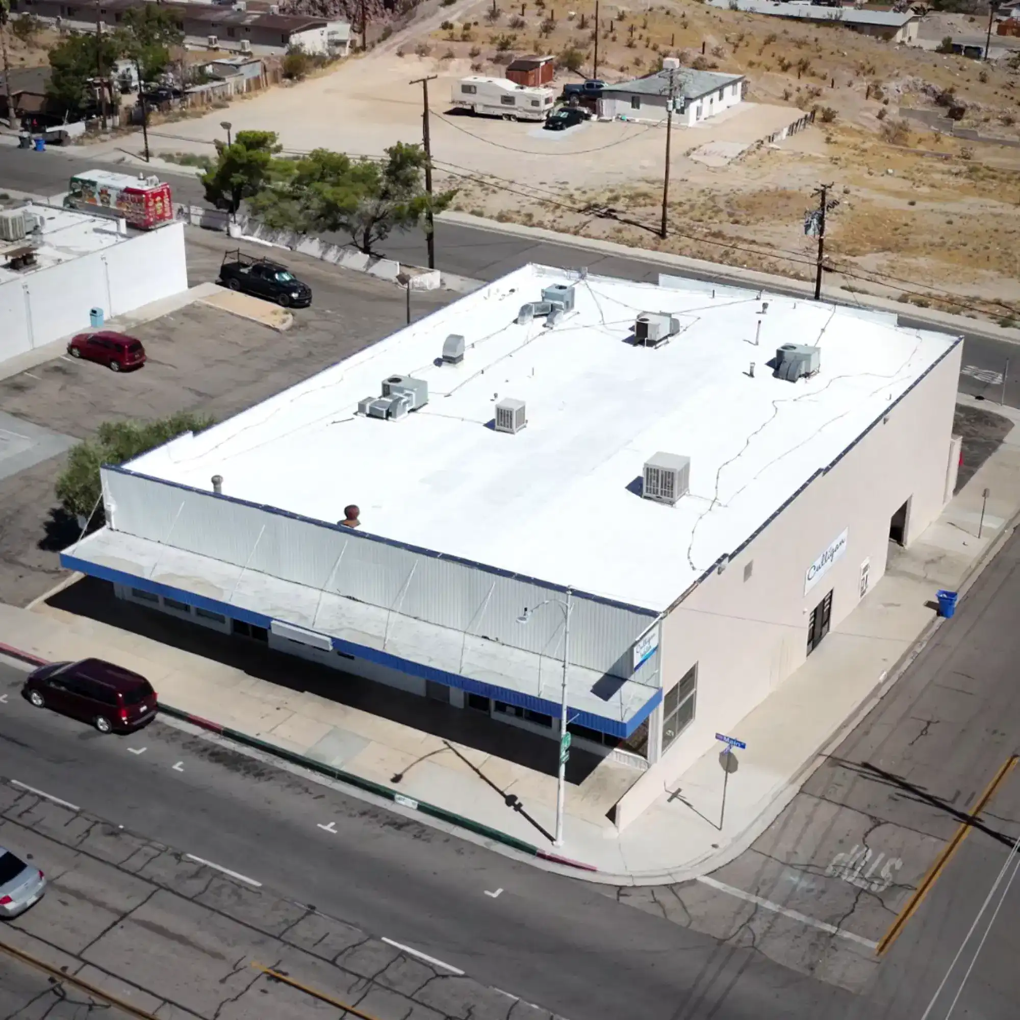 White reflective roof coating on a commercial flat roof