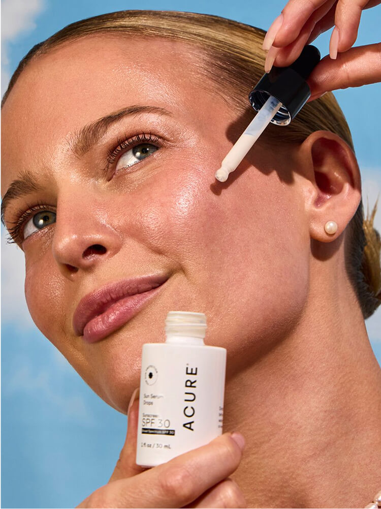 Two toddlers in puffy jackets playing in the snow.