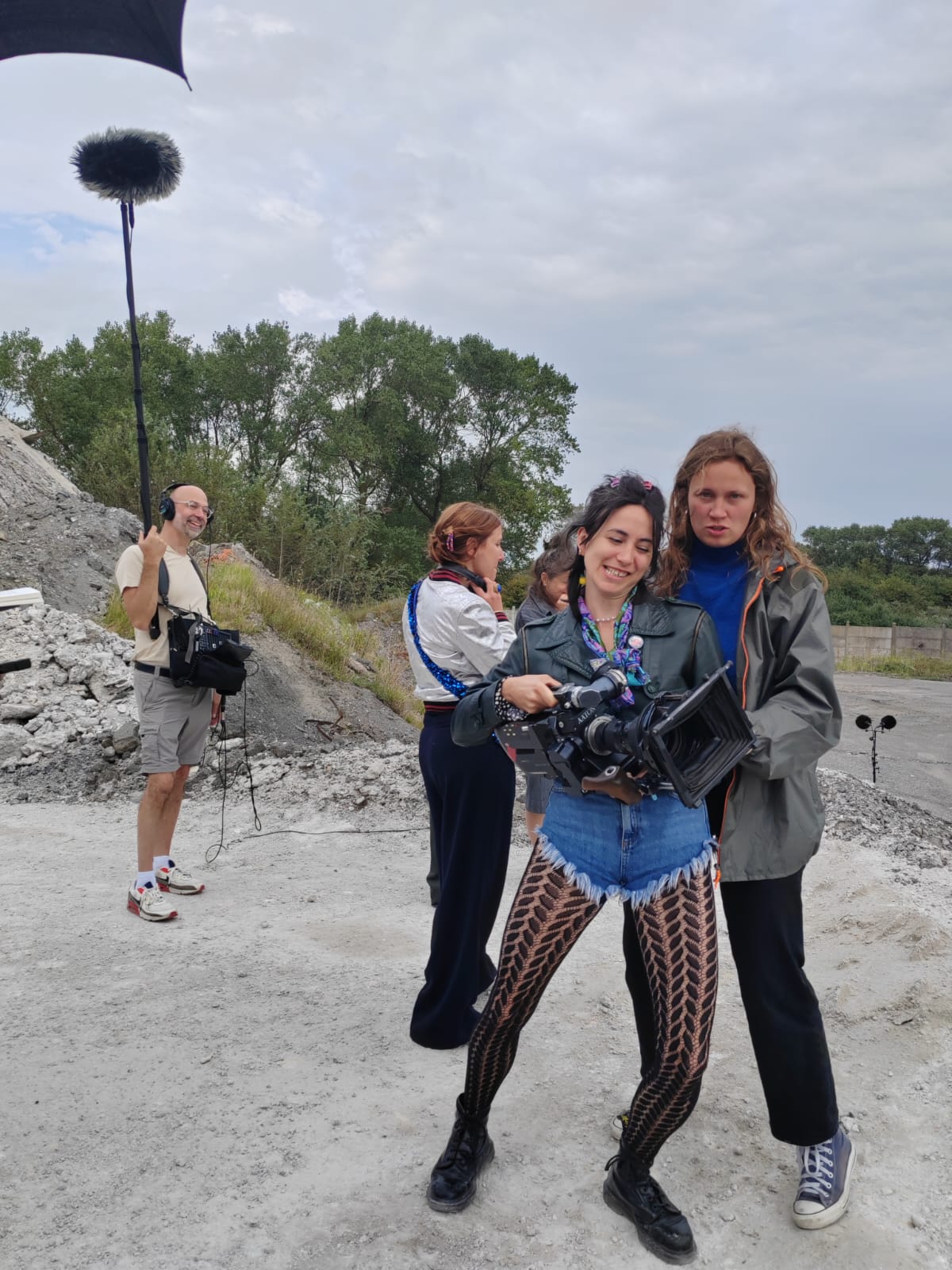 Woman in pink leather jacket crouching outdoors at night