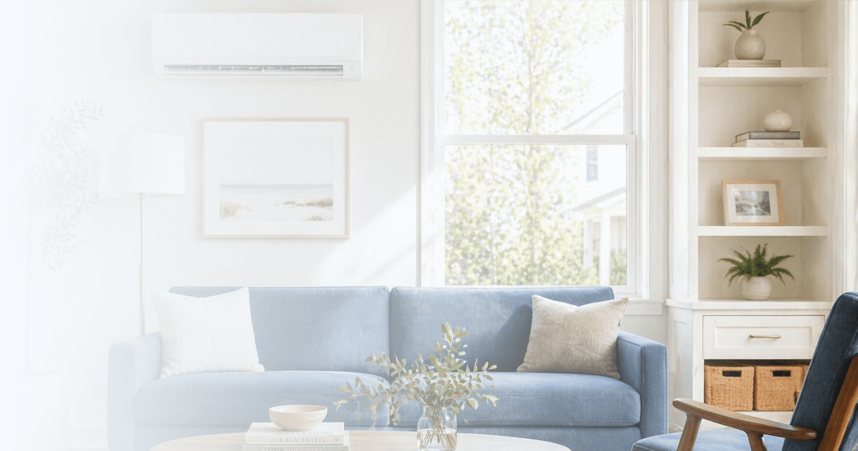 Bright modern living room with a blue sofa, wooden coffee table, plants, built-in shelves, and a large sunlit window.