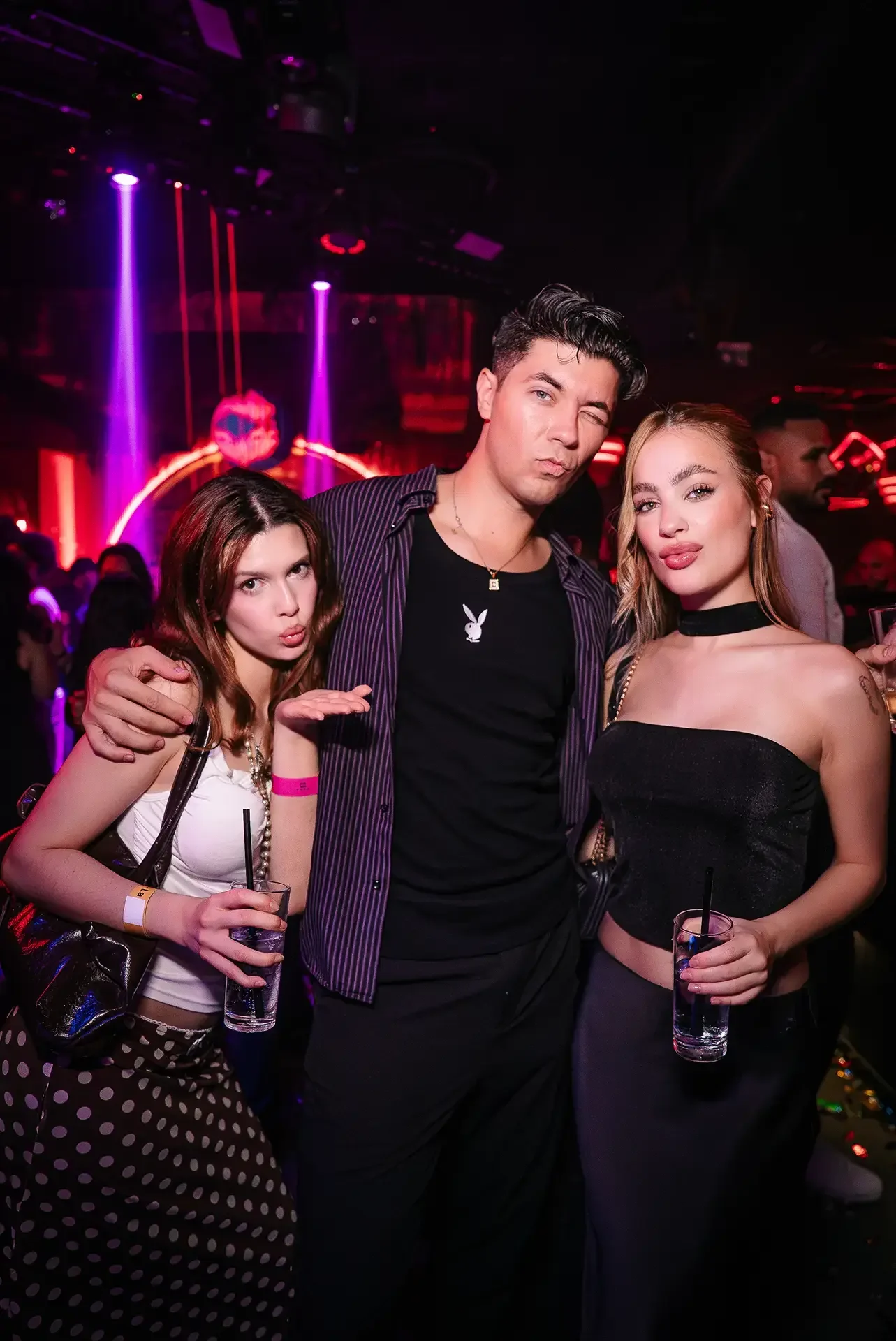 Three guests posing for a photo on a night out at PAPA Dubai
