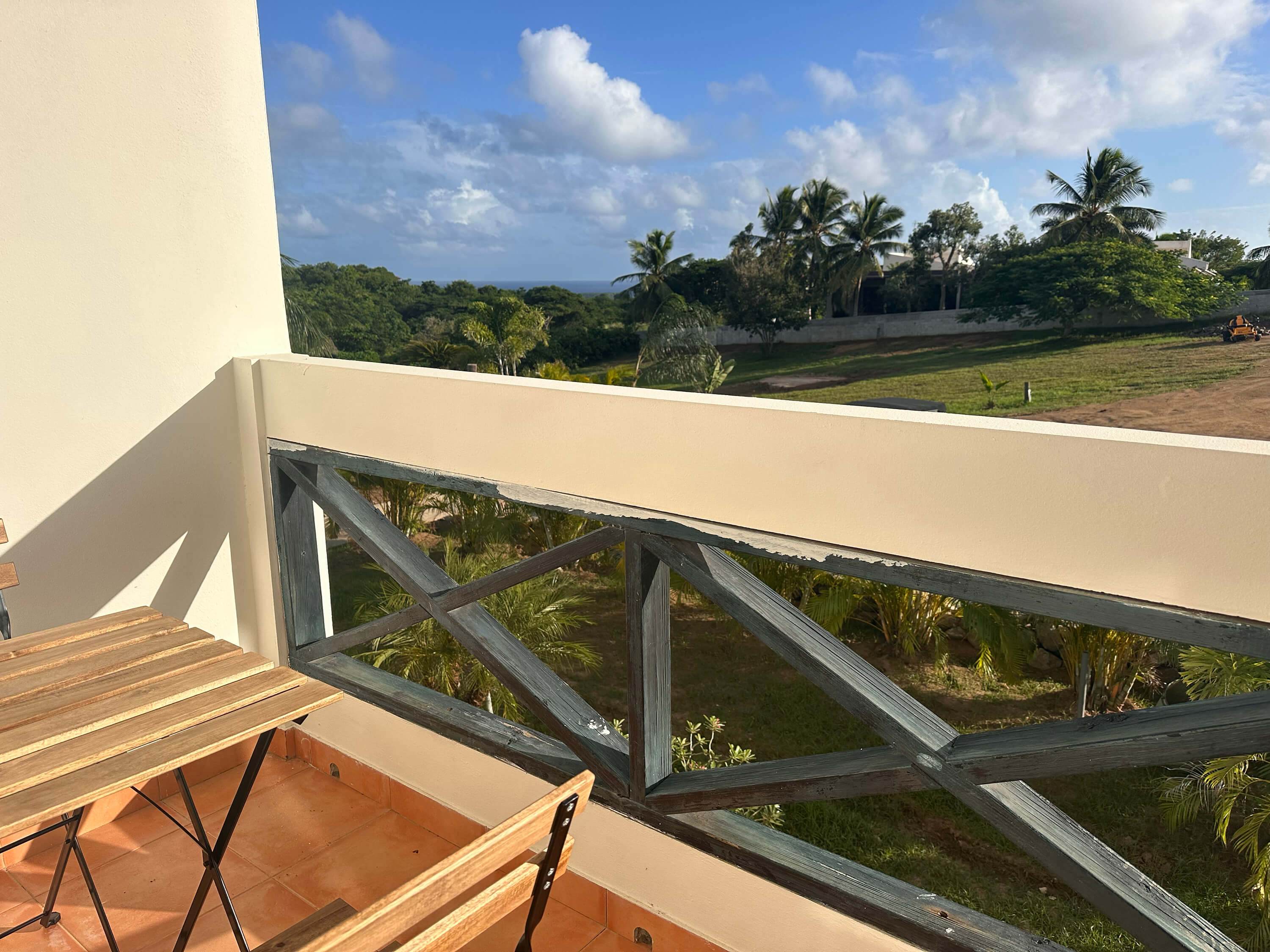 Another perspective of the terrace view from Room 6, showing outdoor seating and the surrounding tropical landscape.