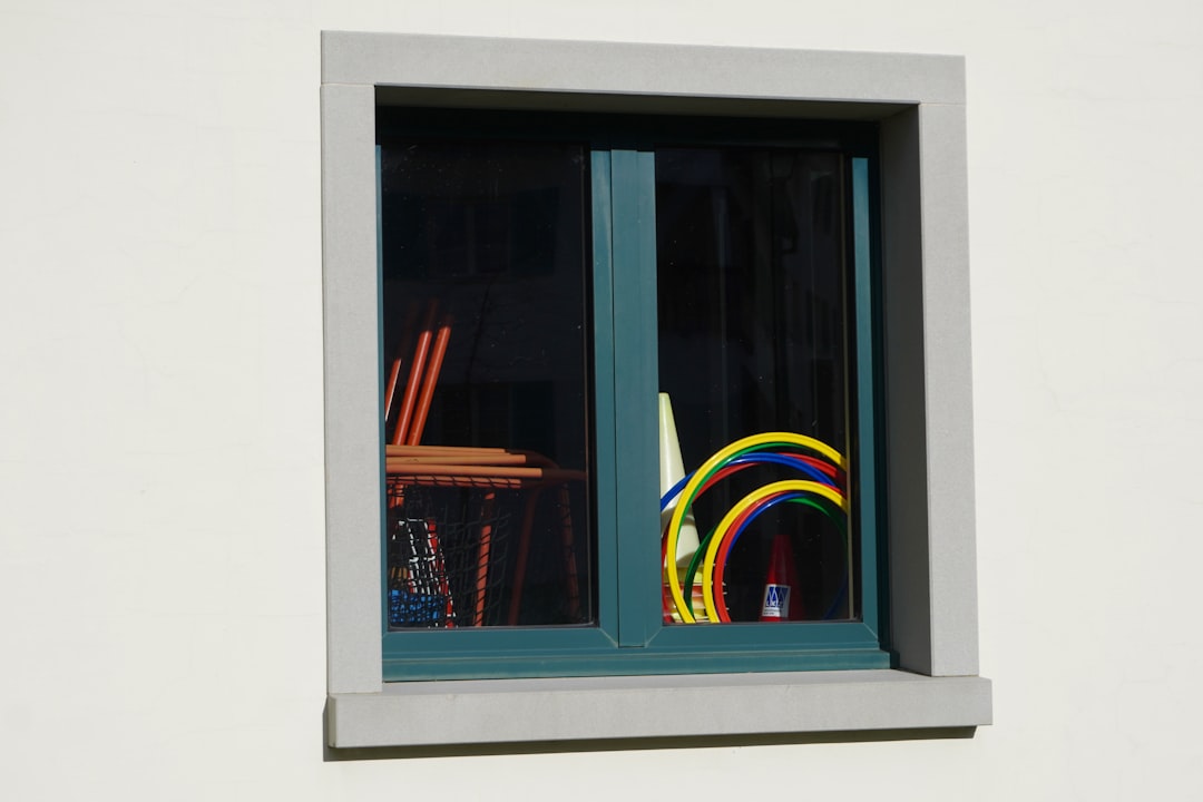 Colorful hoops and art supplies seen through a window.