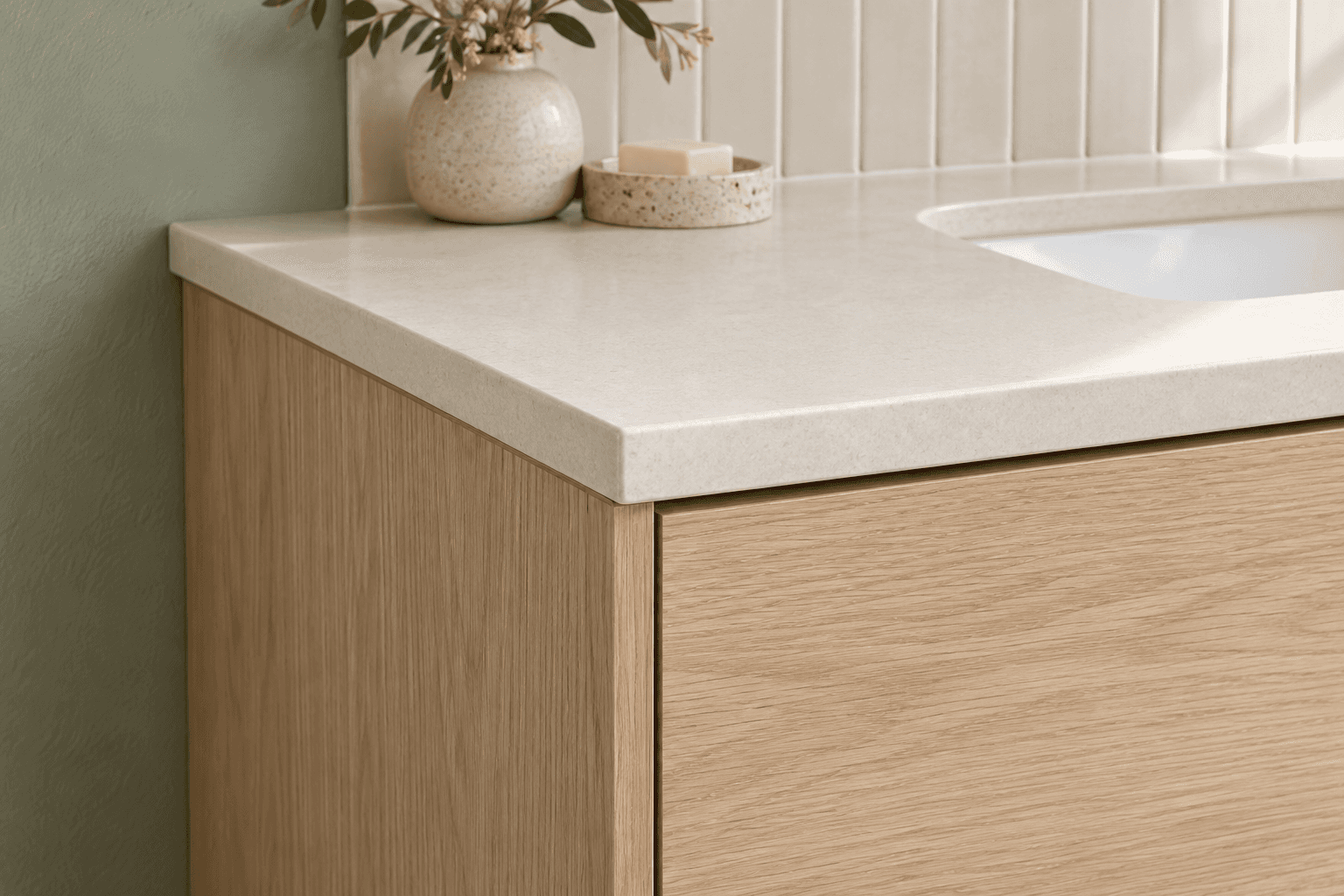 AI detail concept showing a pale countertop edge above wood-grain cabinetry beside muted green and warm white surfaces.