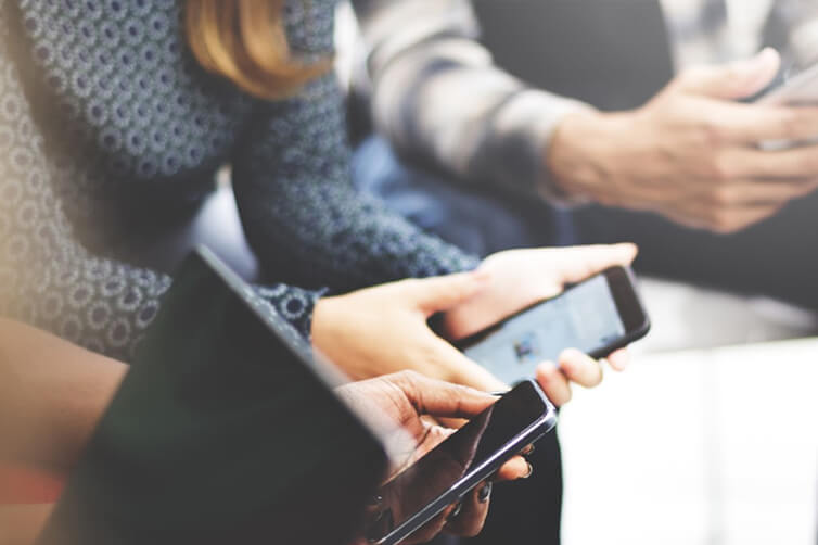 People using smartphones in close-up view