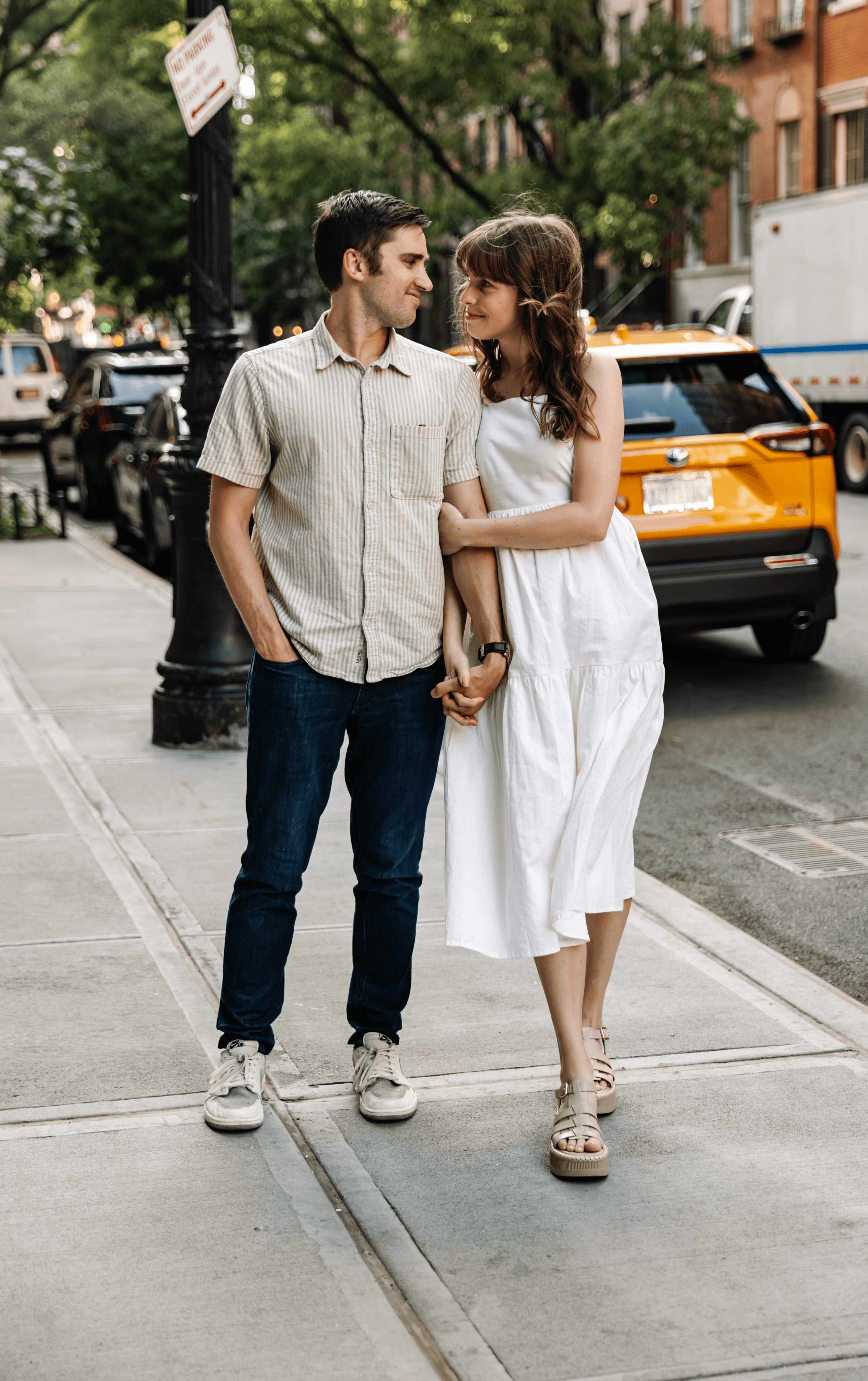 Couple walking through an iconic New York City location, hand in hand — effortless, candid couples photography by Lizz Spano Photography, New York City couples photographer.