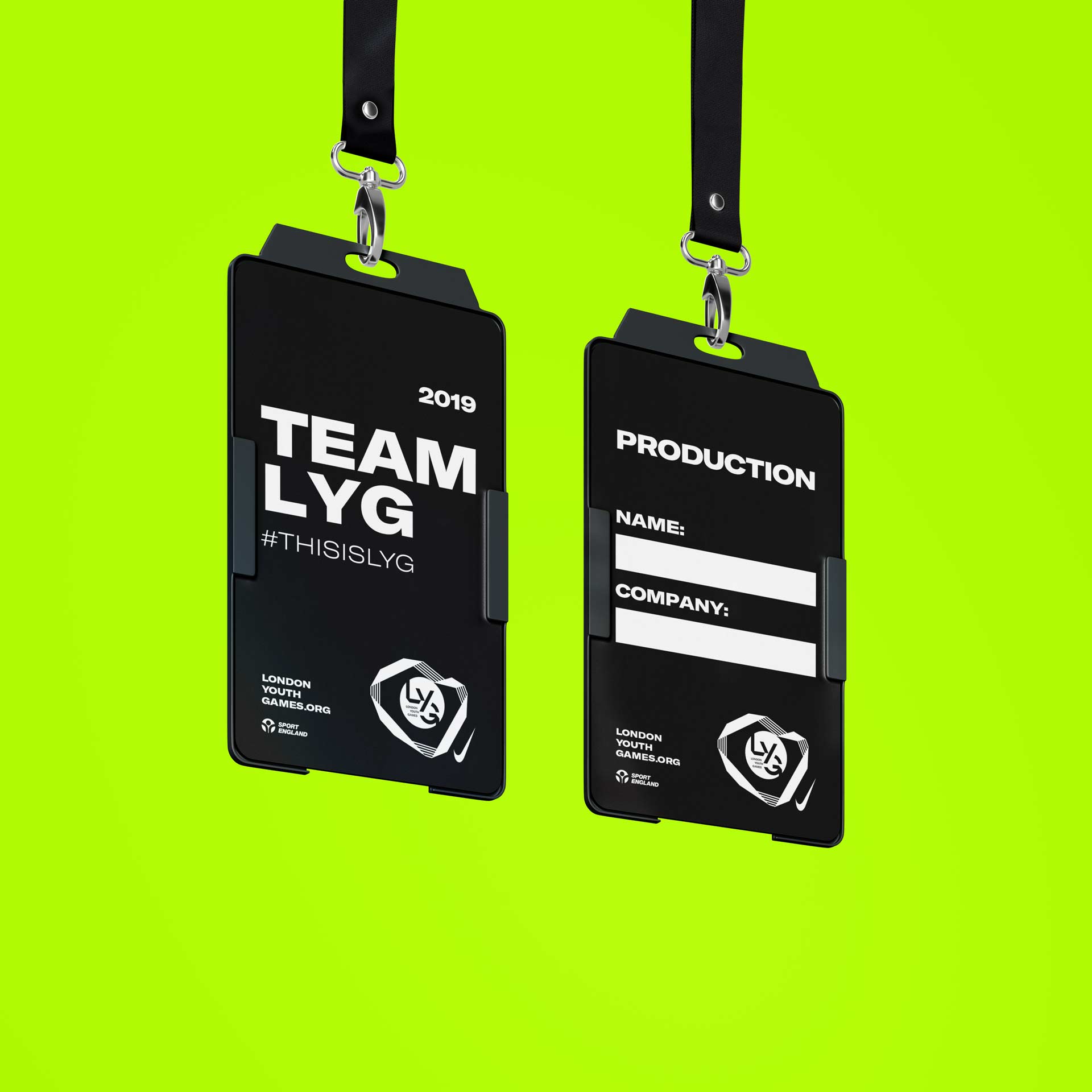 Event ID badges for TEAM LYG 2019 hanging on lanyards with fields for name and company details on a vibrant green background, showcasing the London Youth Games branding.