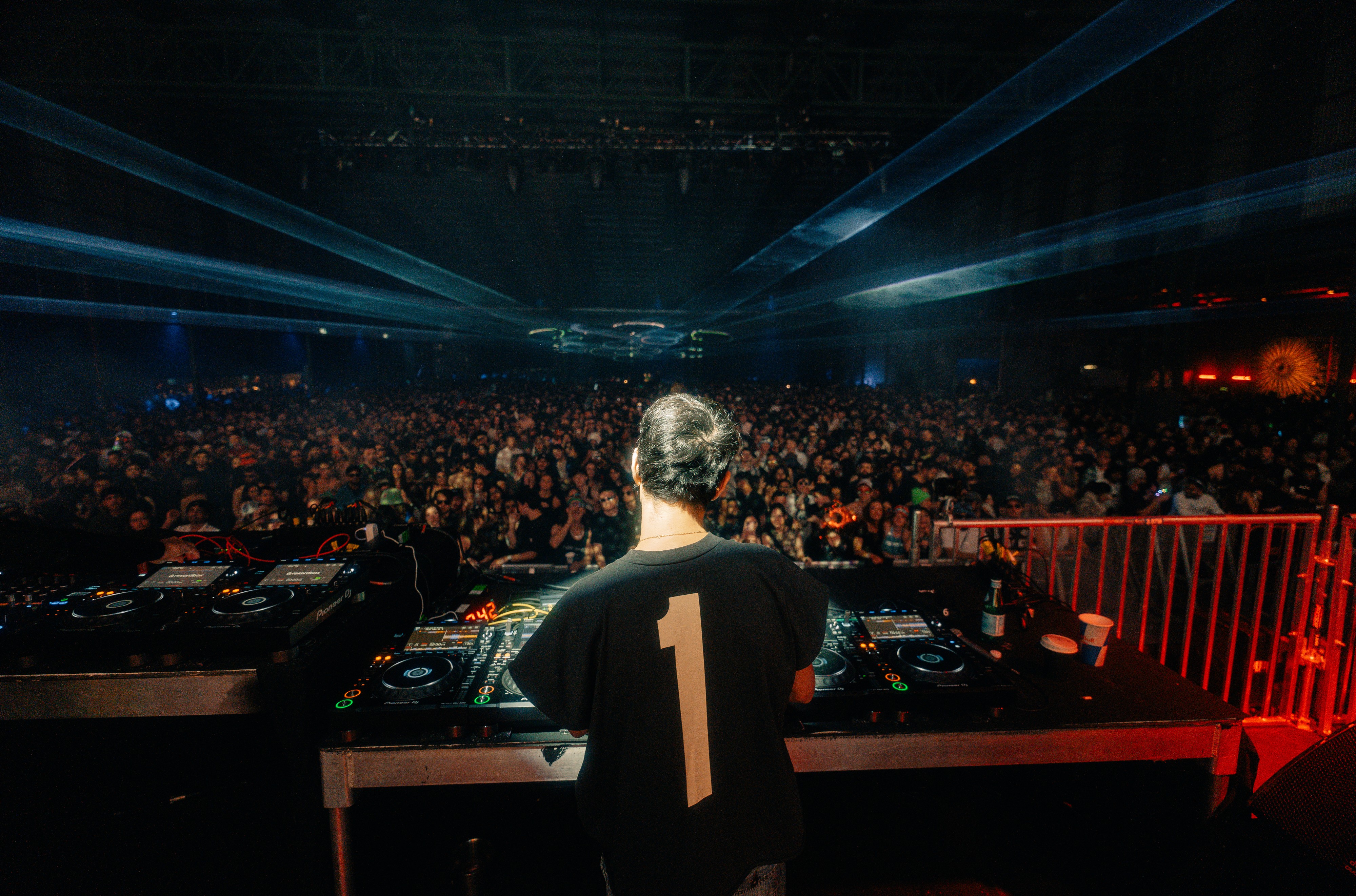 DJ playing to a large crowd at Paradigm Festival
