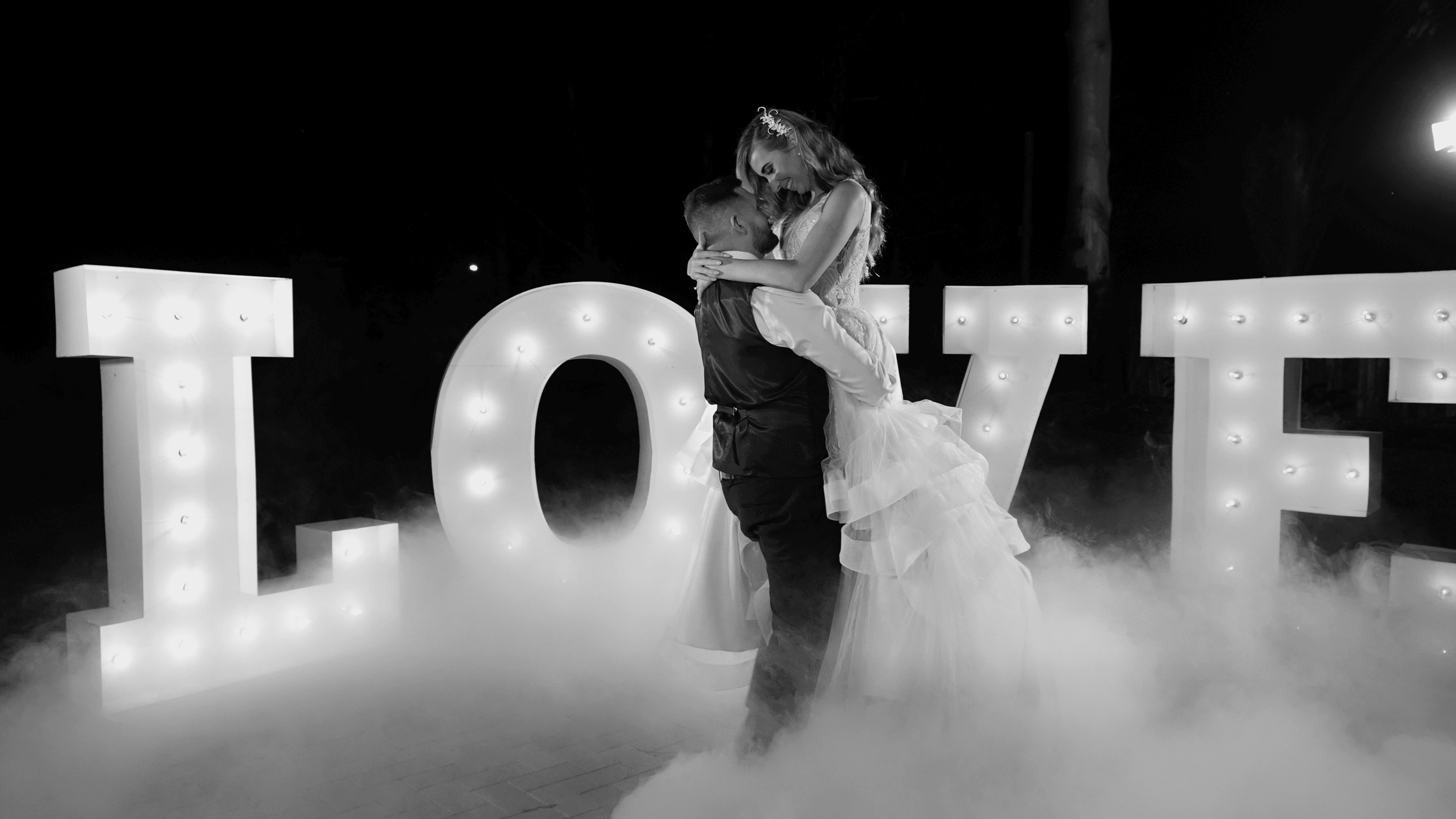 Holly & Storm having their first dance edited into stunning black and white for their wedding video at Bundaleer Rainforest Gardens