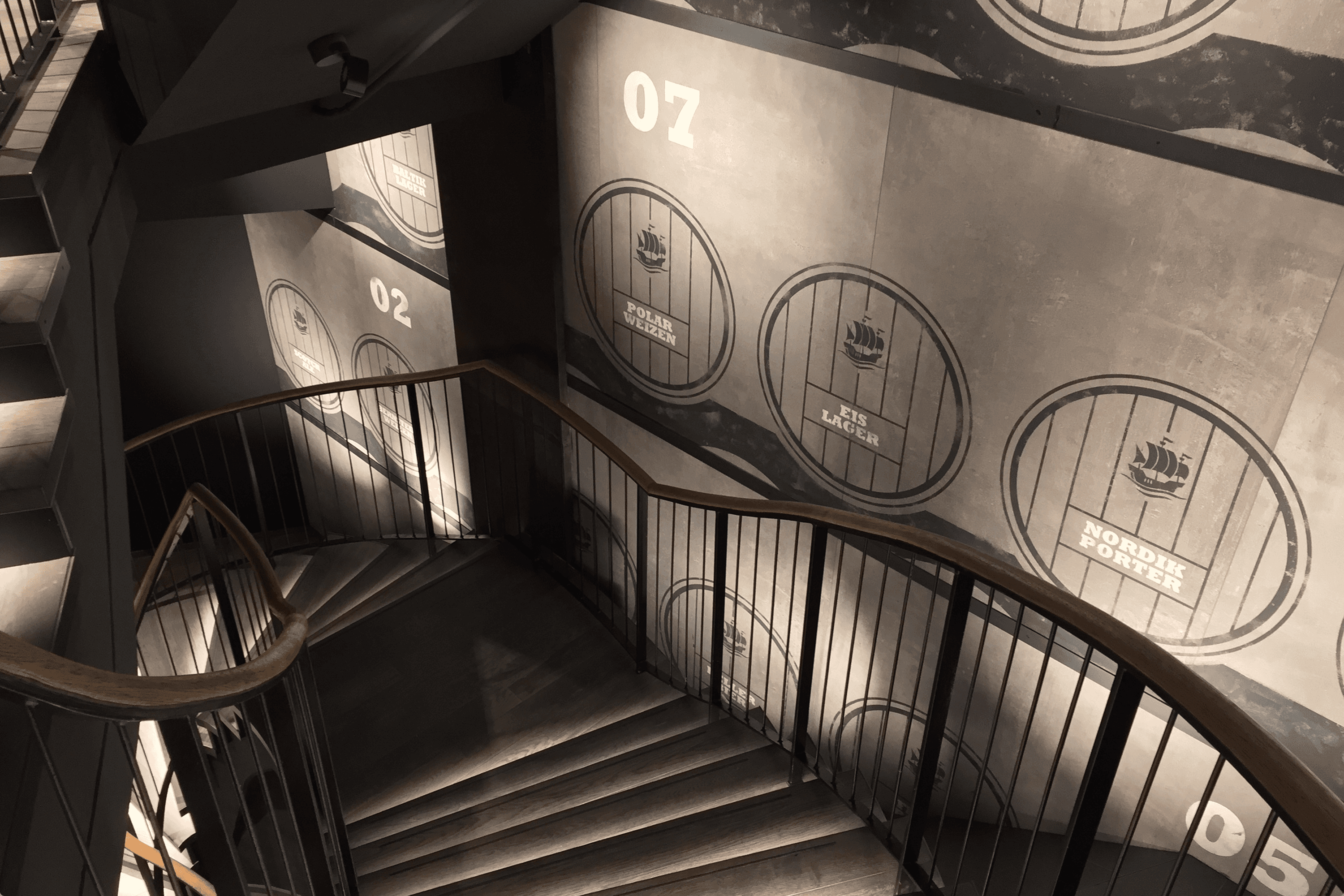 Spiral staircase with brewery barrel artwork