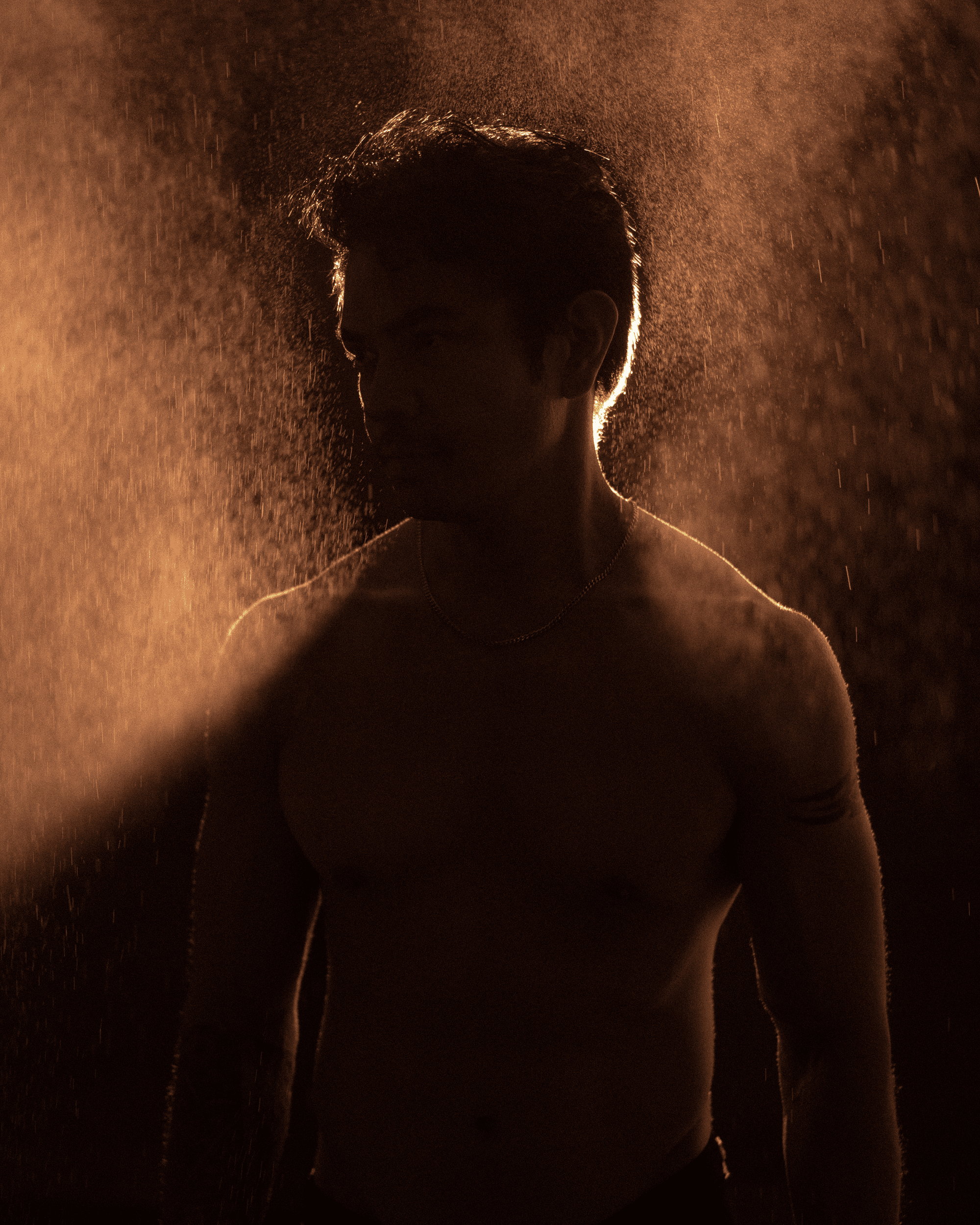Silhouette of a person in a dimly lit sauna, illustrating the contrast between traditional sauna heat and steam room environments