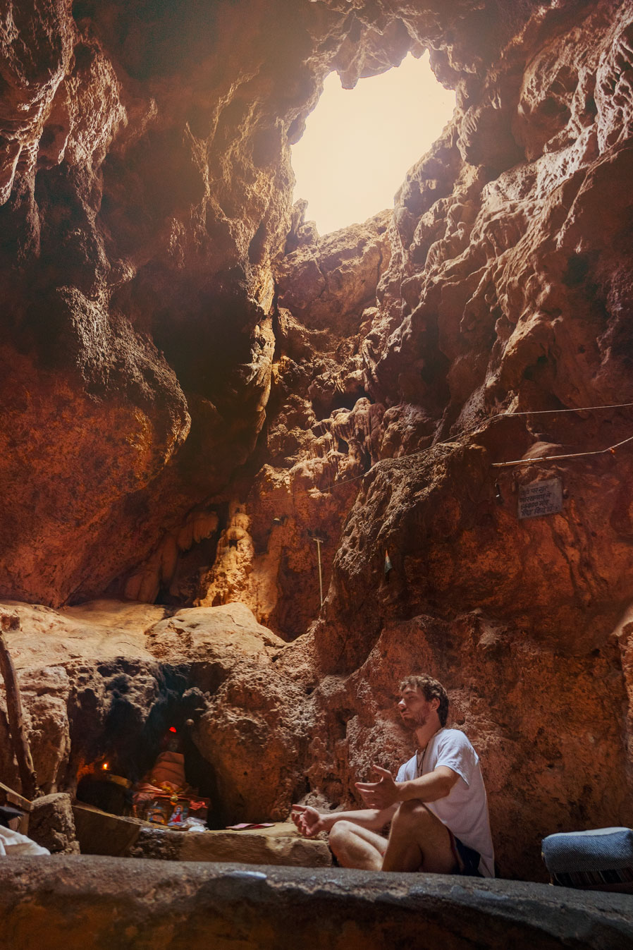 Meditating inside the sacred place Jhilmil Gufa near Rishikesh in India