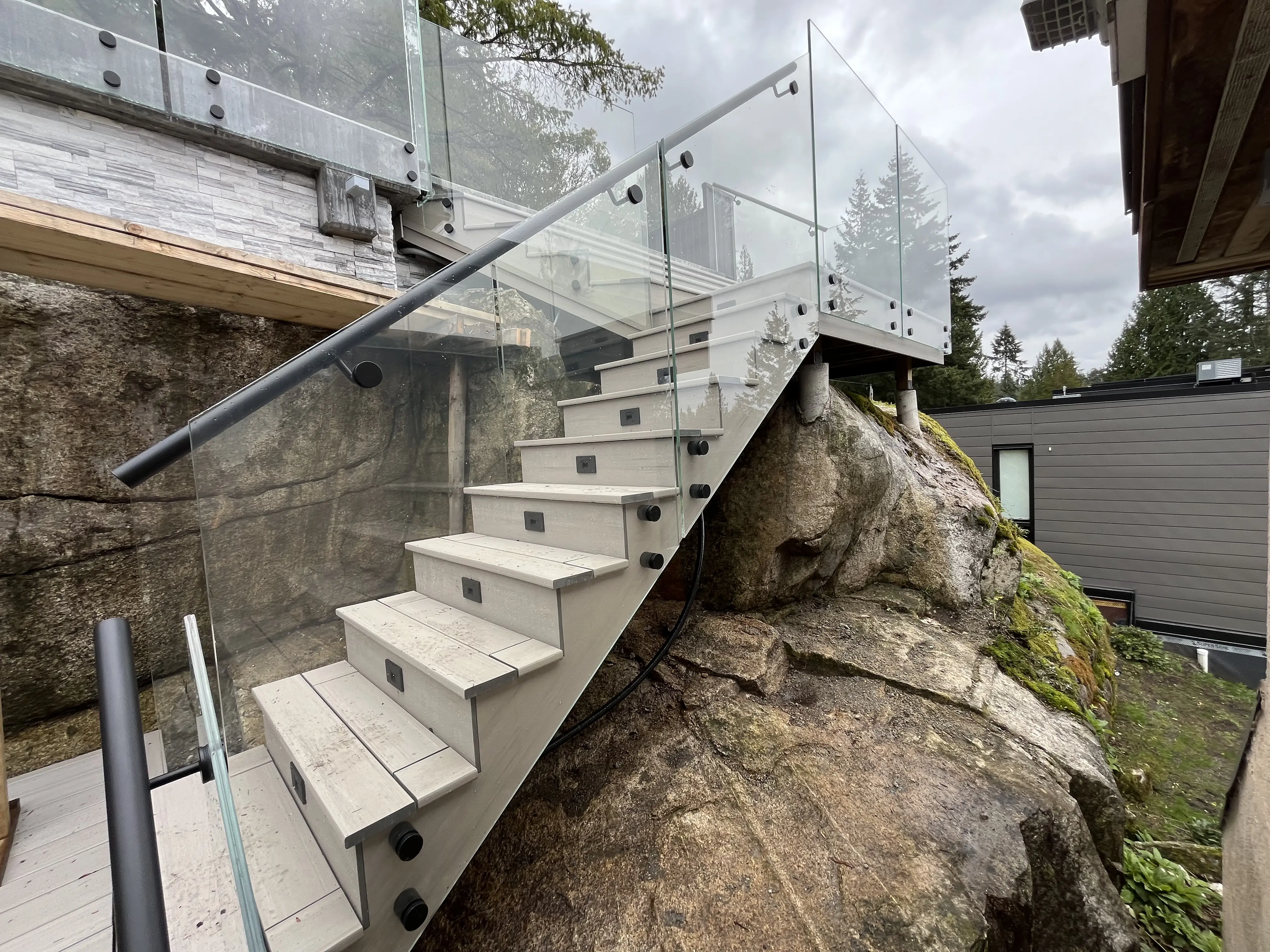 Custom glass railings for stairs and loft spaces in a modern home with open architectural design and premium finishes.