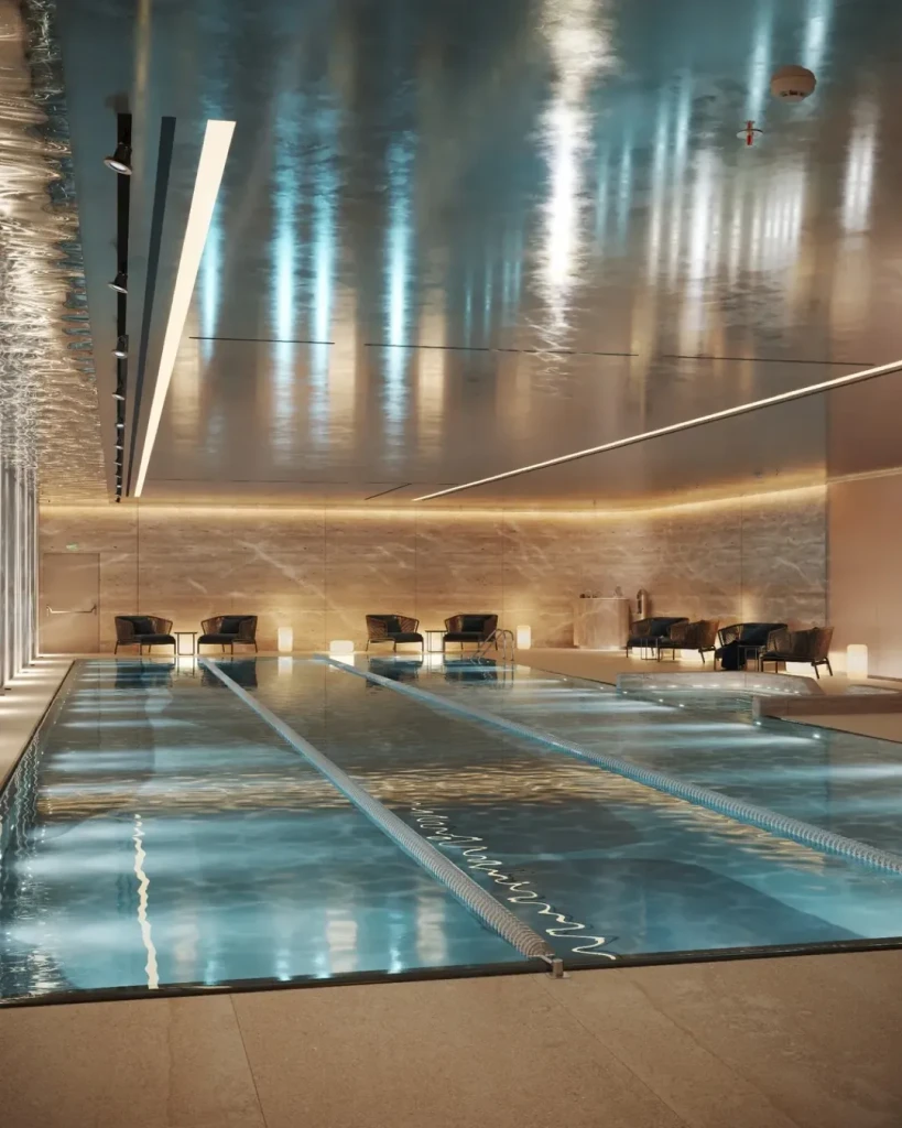 A modern pool with a spacious glass door, representing Teal at Verdes by Haven.