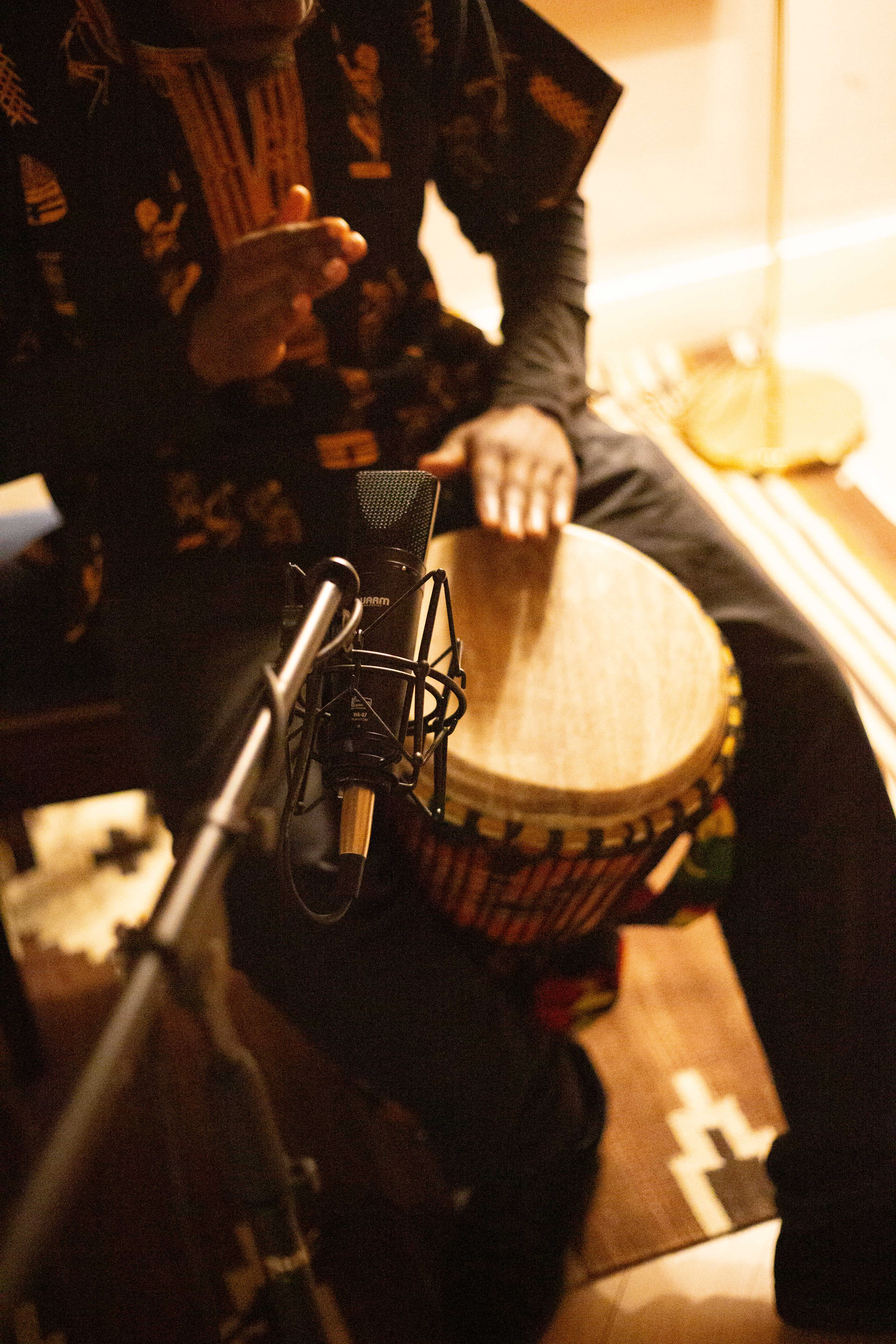 Musician recording percussion in the studio.