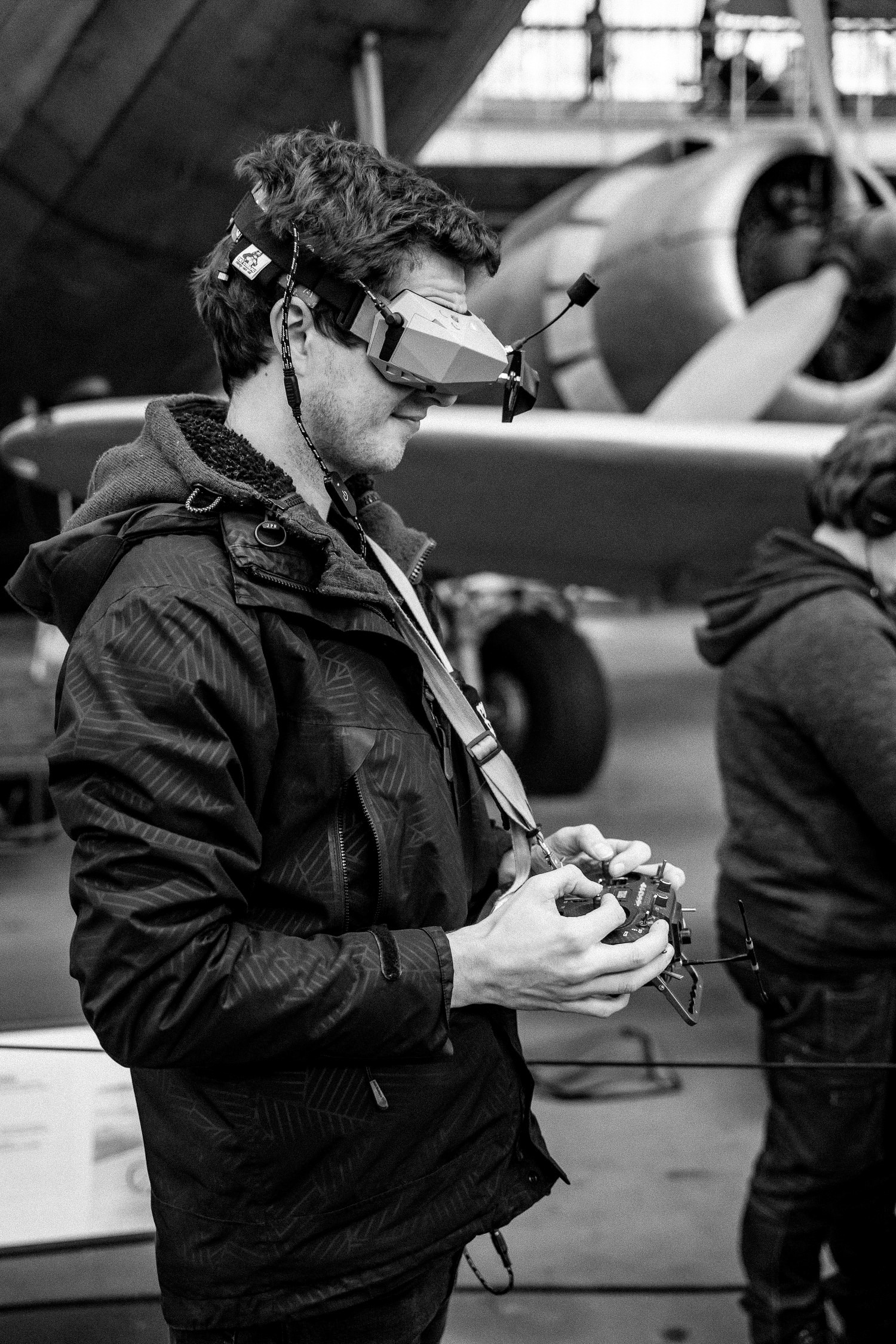 Drone pilot with FPV goggles and a remote control in his hands