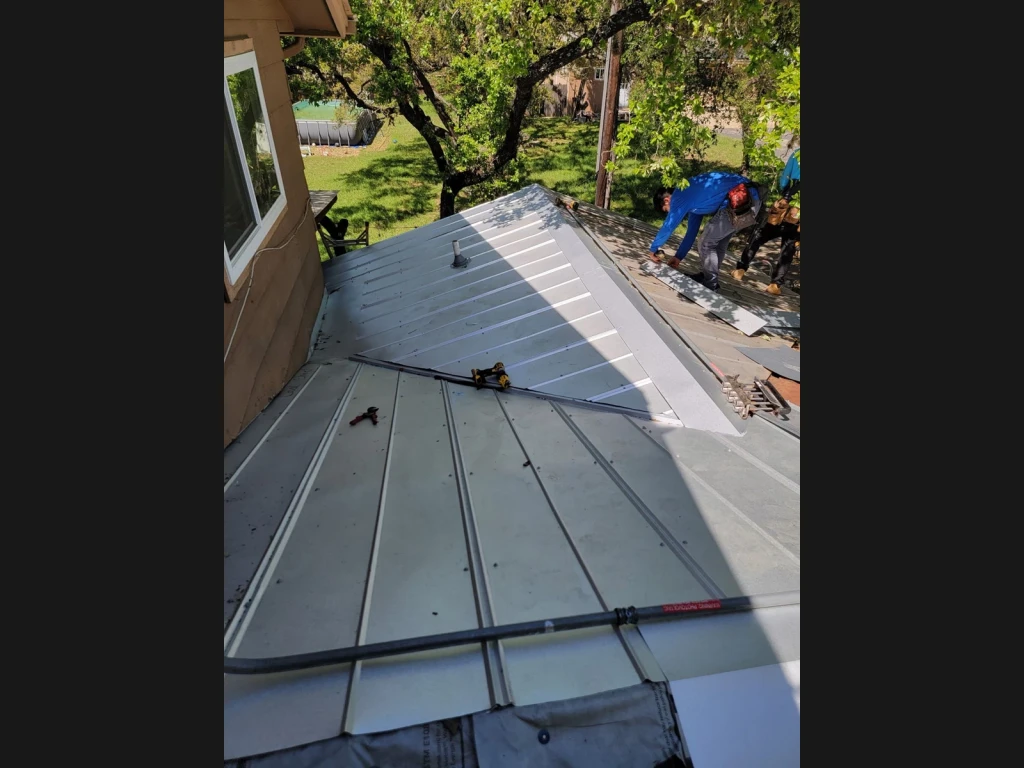 Re-covered 5V metal roof beside the wall in Bulverde, Texas.